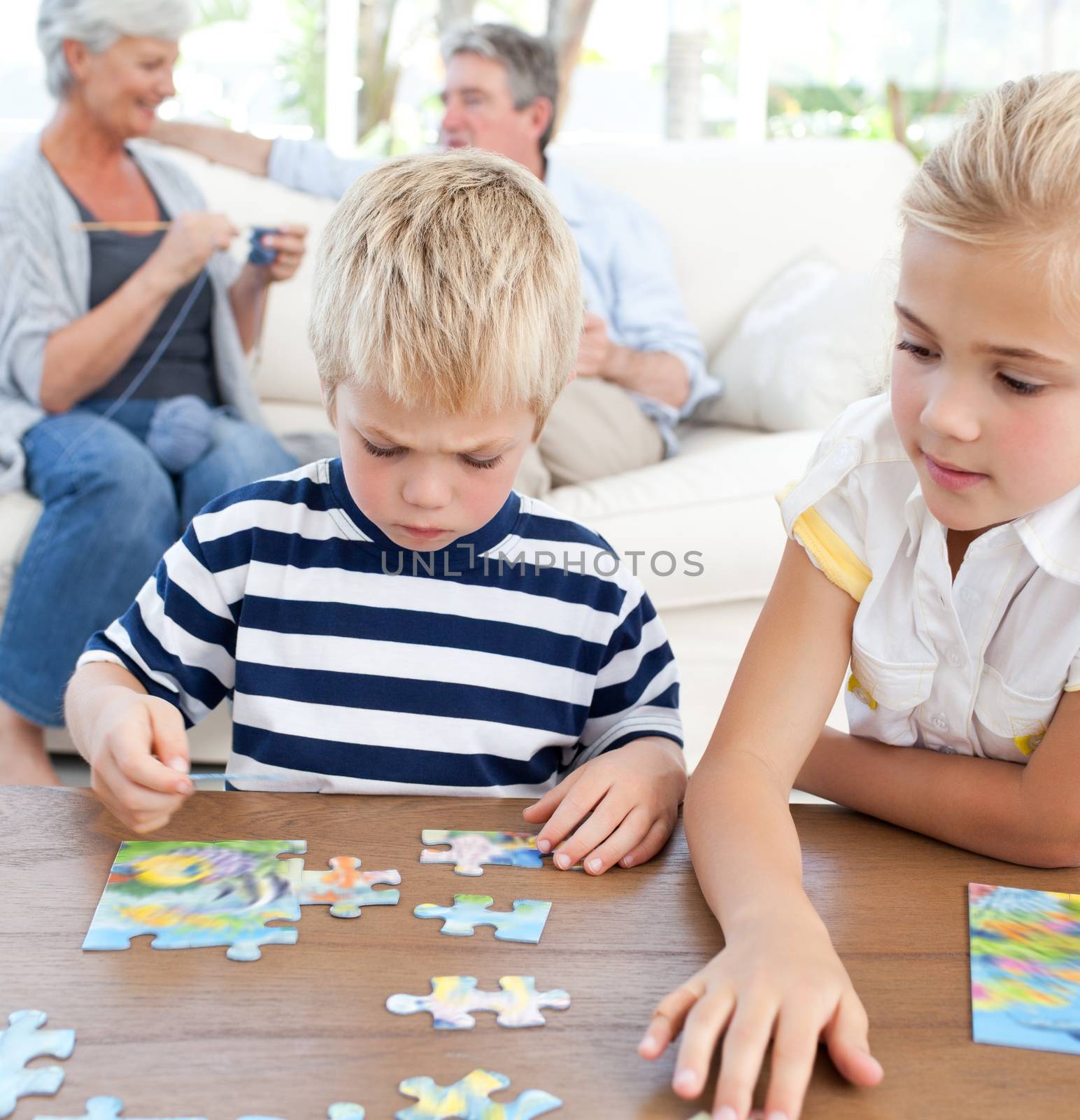 Children playing puzzle in the living room