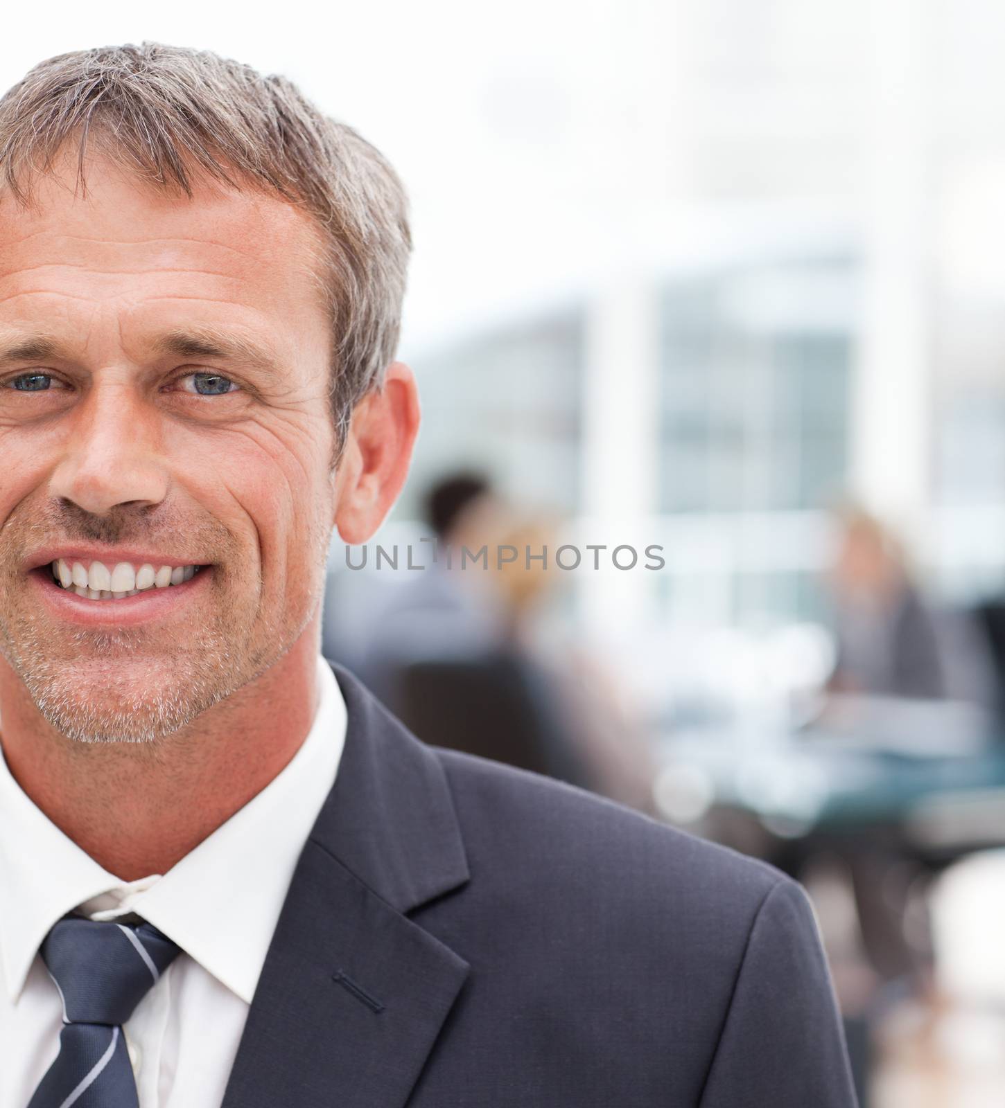 Smiling businessman in his office by Wavebreakmedia