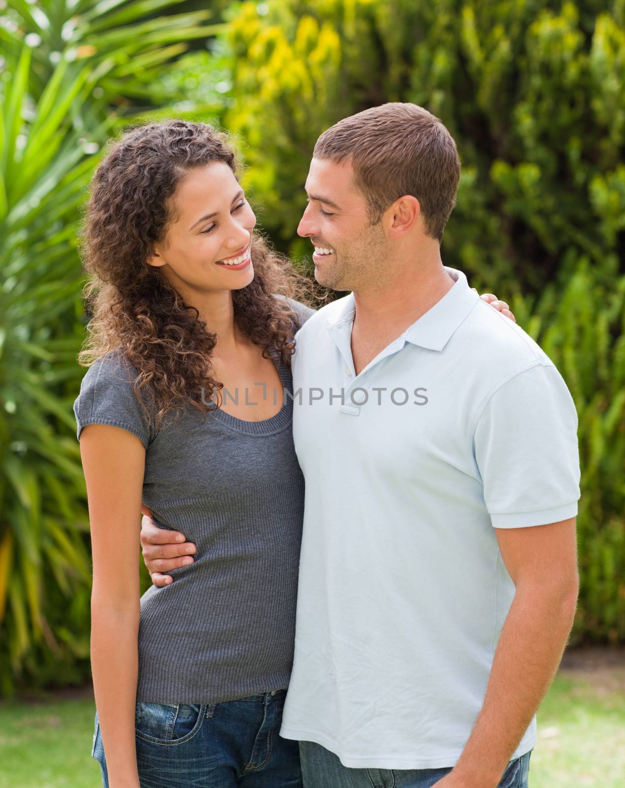 Happy couple hugging in the garden