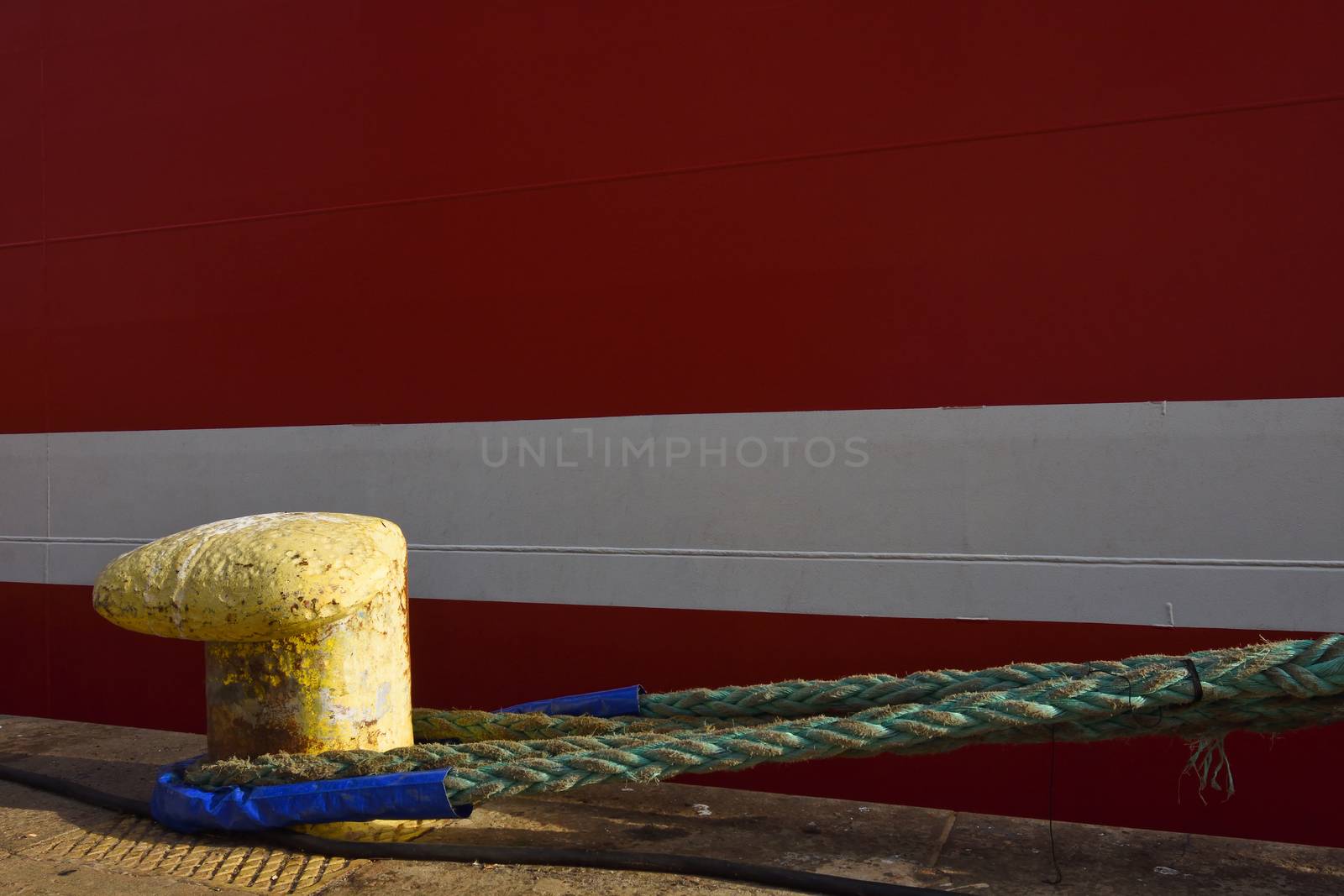 Ships Mooring Line Attached To A Bollard by jjvanginkel