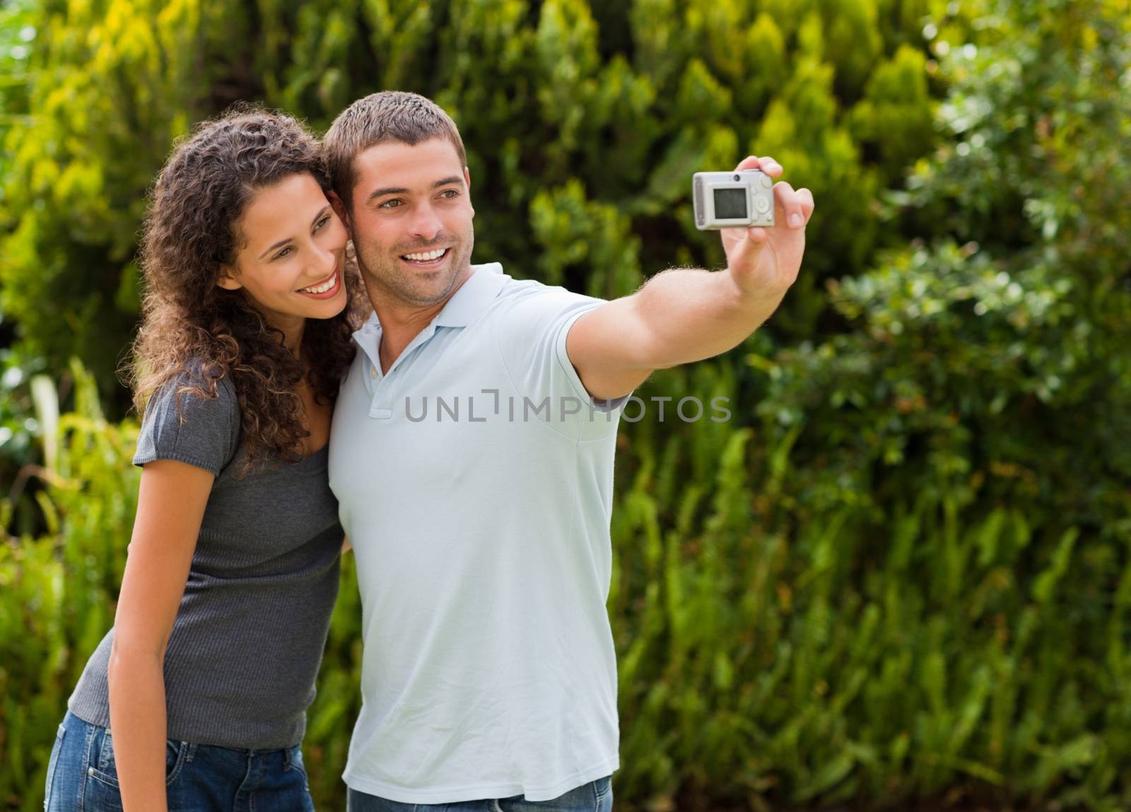 Couple taking a photo of themselves in the garden