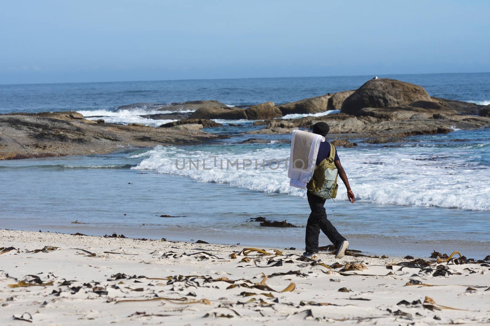 Art Vendor Walking On African Vacation Beach by jjvanginkel