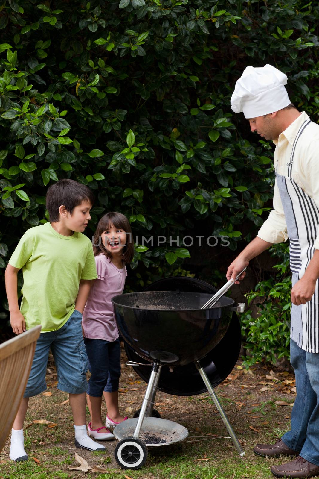 Family having a barbecue in the garden  by Wavebreakmedia