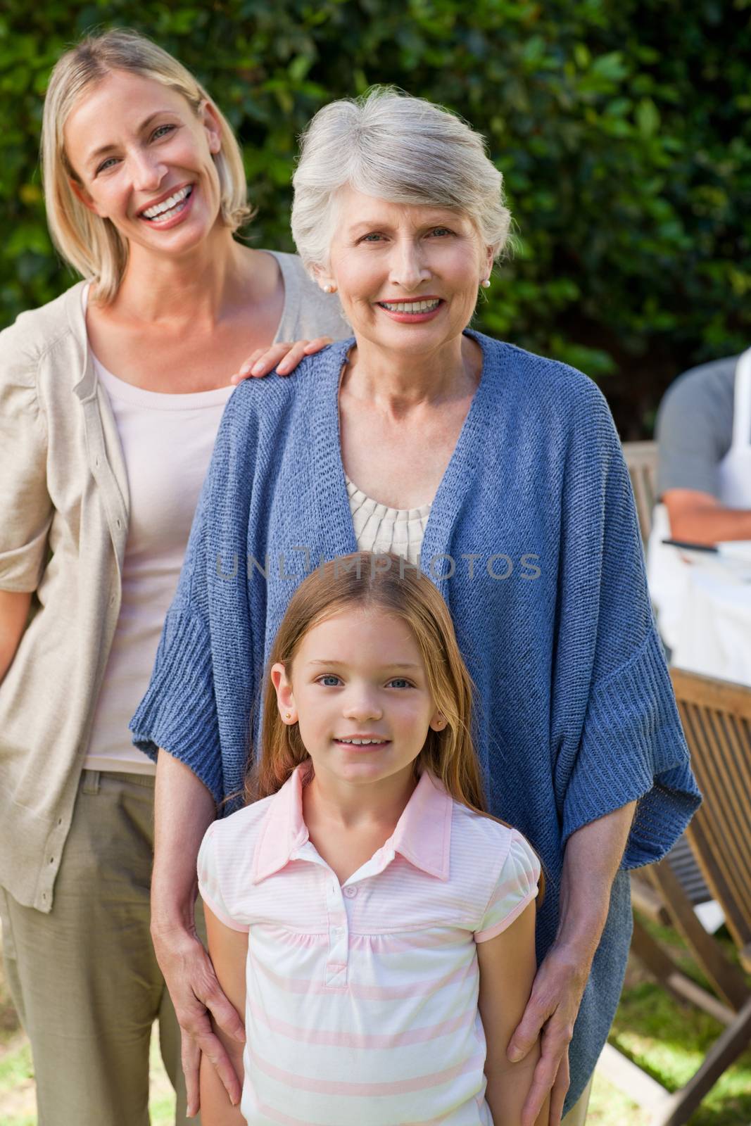 Family looking at the camera in the garden by Wavebreakmedia