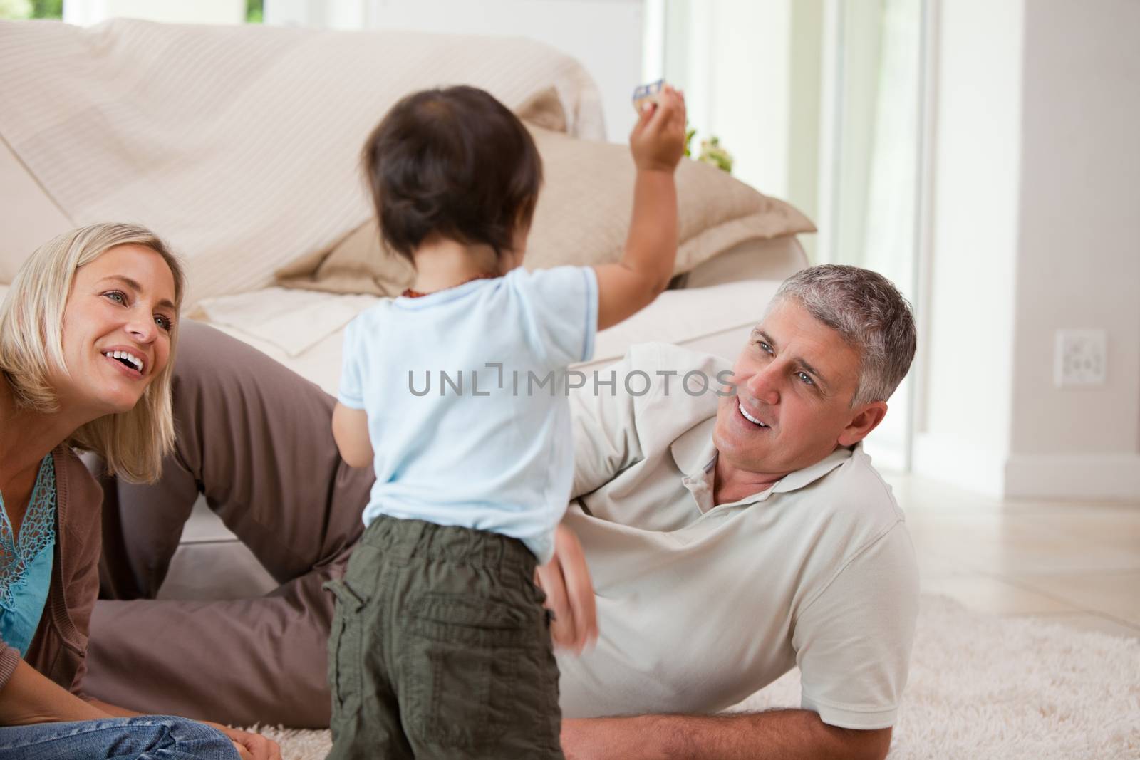 Son playing with his parents at home