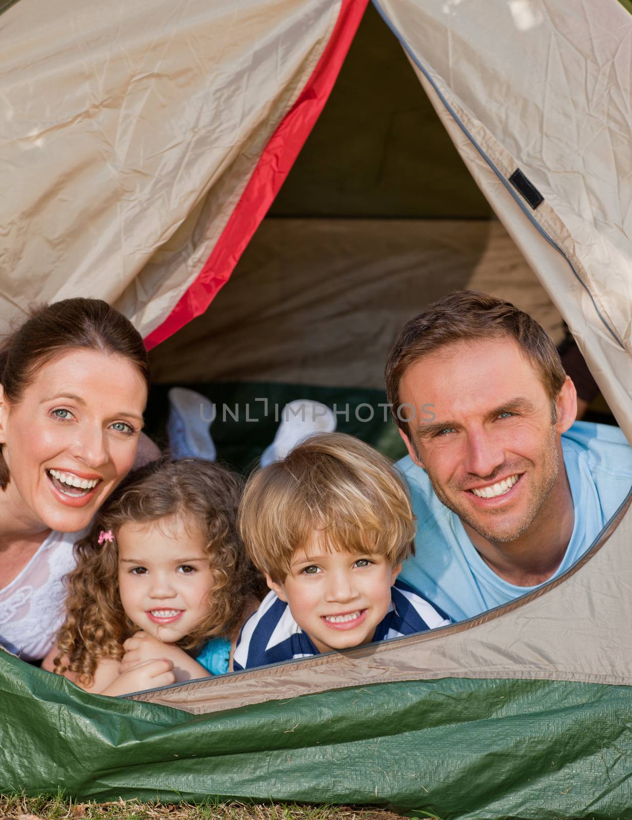 Joyful family camping in the garden by Wavebreakmedia