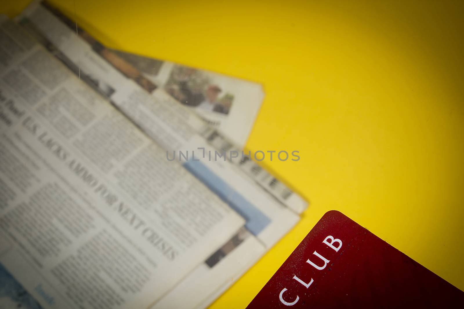 Club card on the background of newspapers