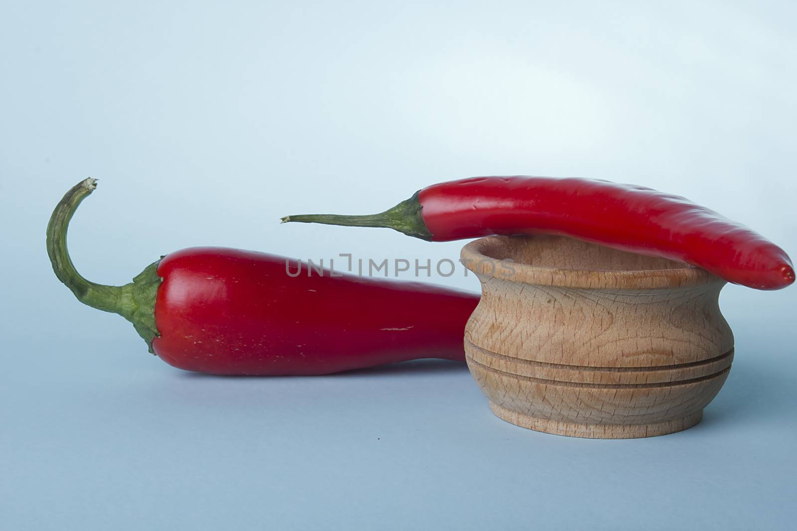 Red pepper and salt shaker on a blue background
