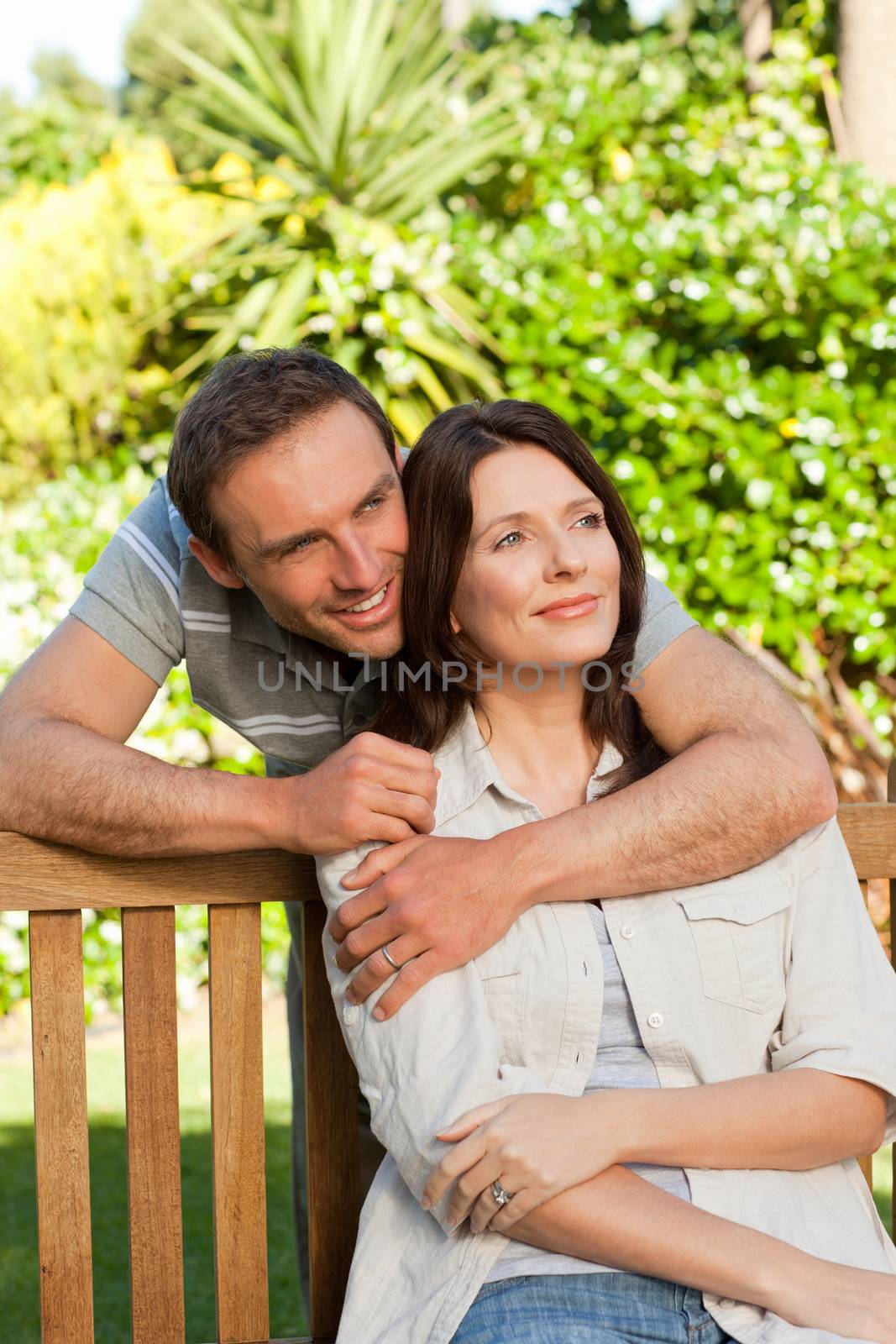 Glad couple hugging in the garden