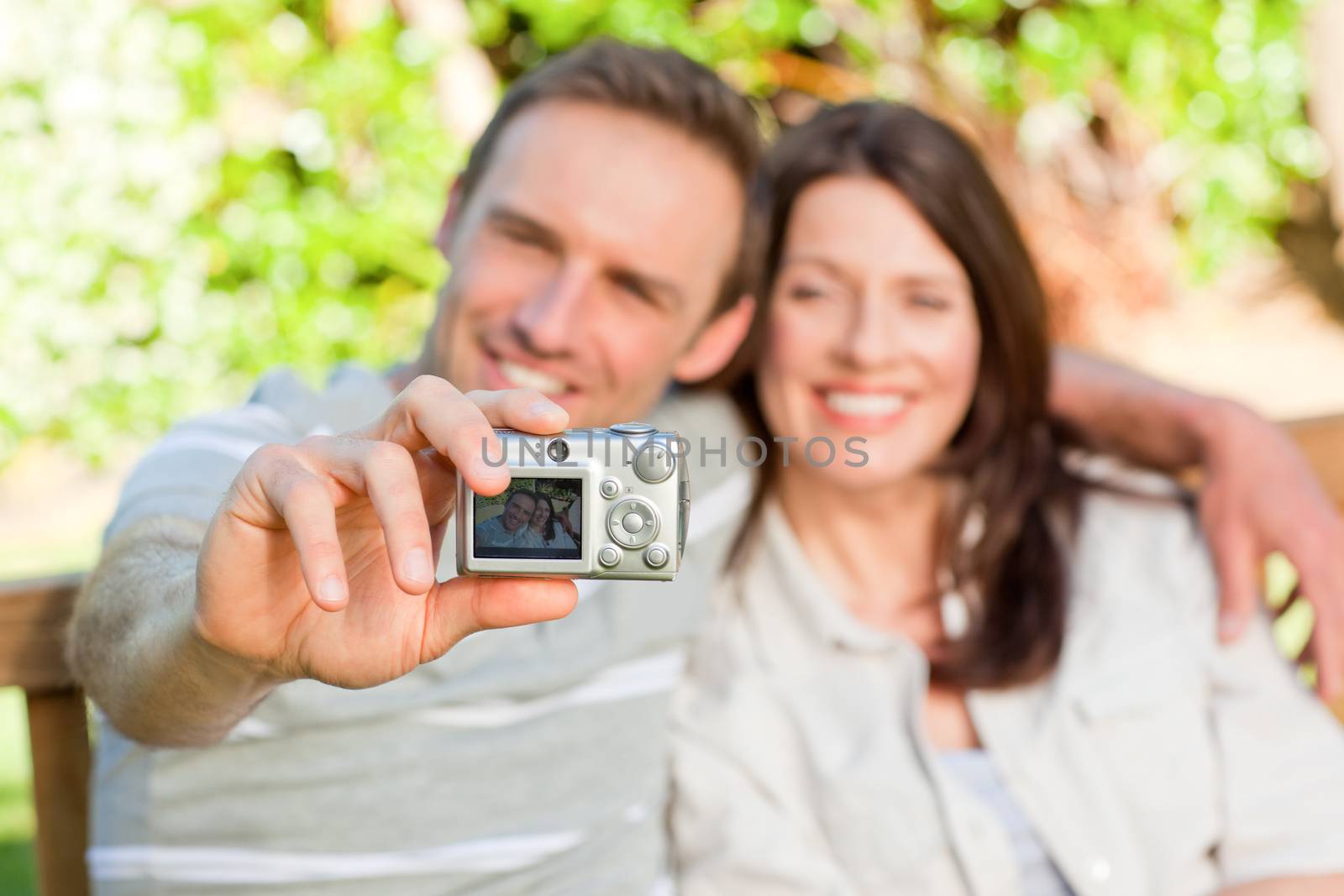 Lovers taking a photo of themselves in the garden