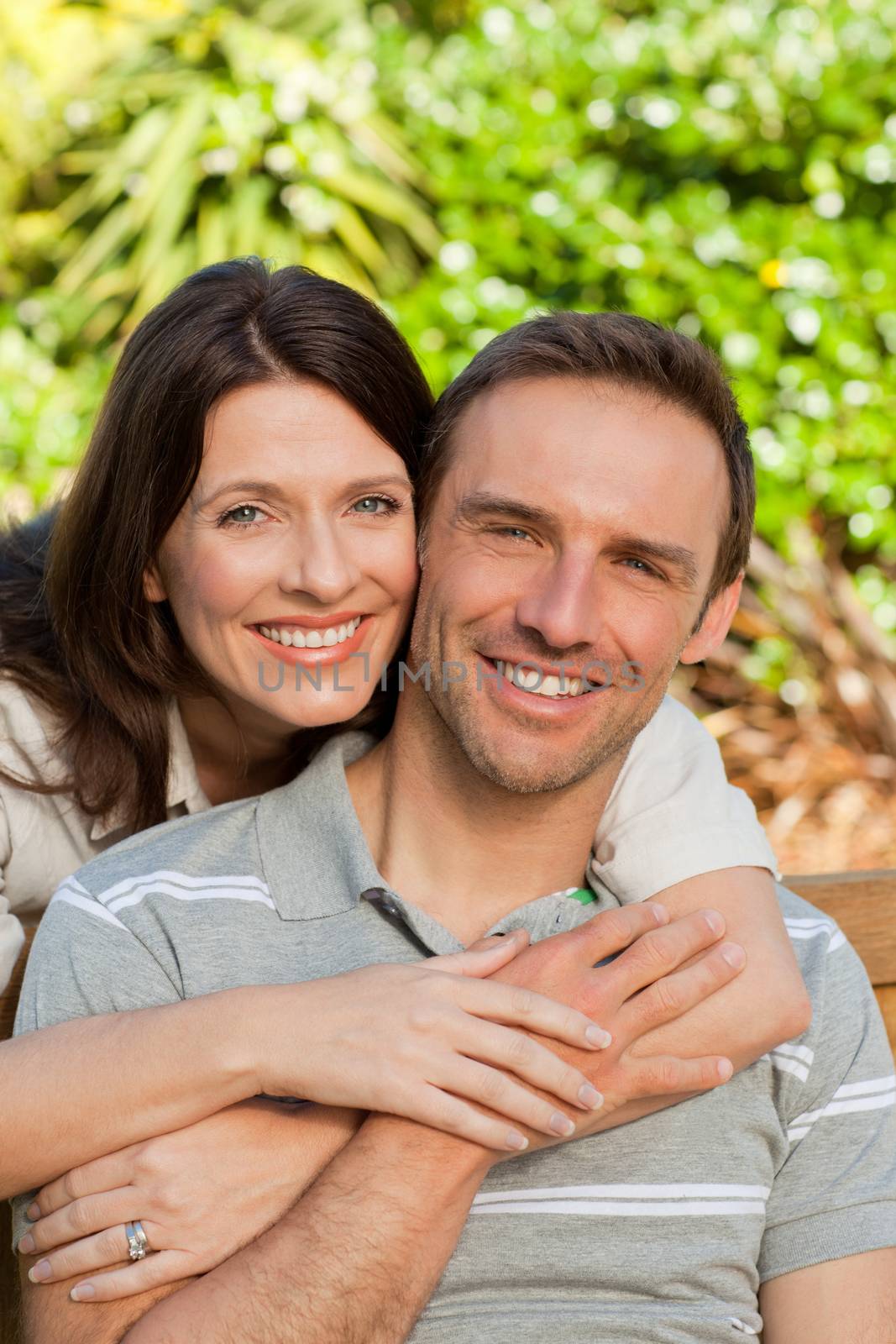 Glad couple hugging in the garden by Wavebreakmedia