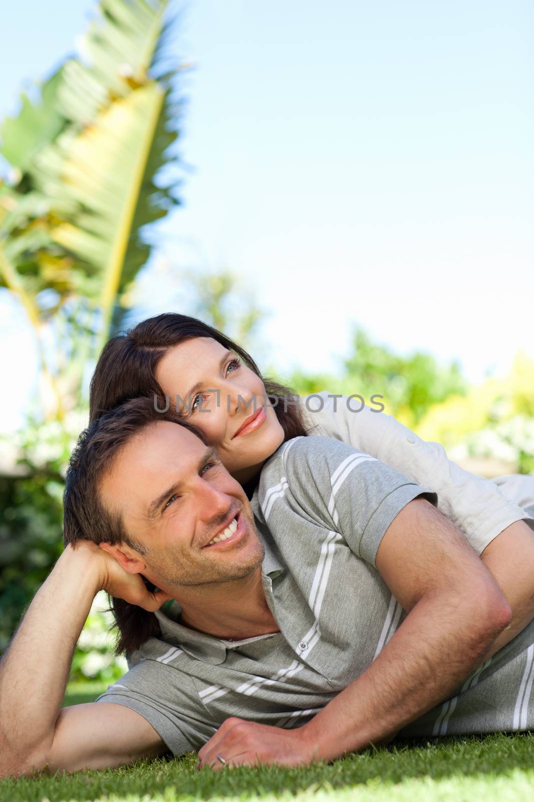 Couple lying down in the garden by Wavebreakmedia