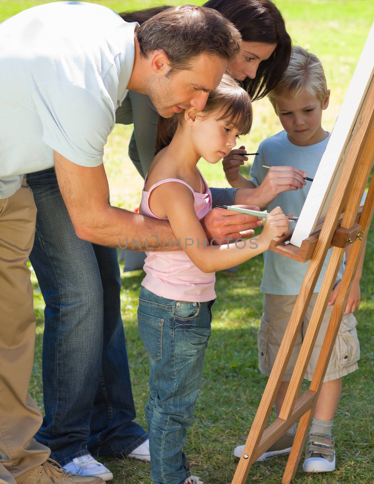 Family painting together in the park by Wavebreakmedia