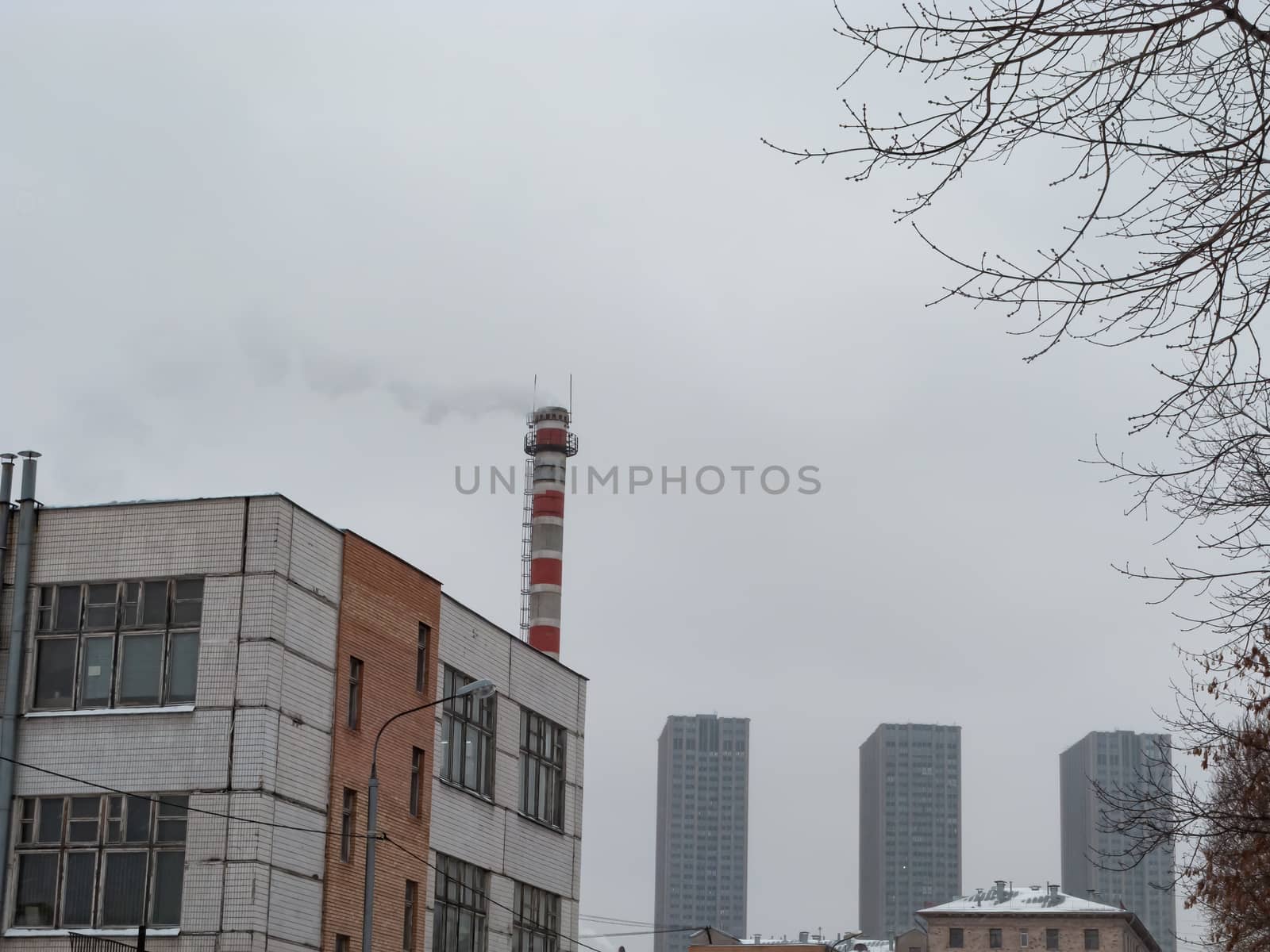 White smoke from an old factory chimney against the sky. Ecology. The concept of the environmental problem of air pollution. Copy space for text.