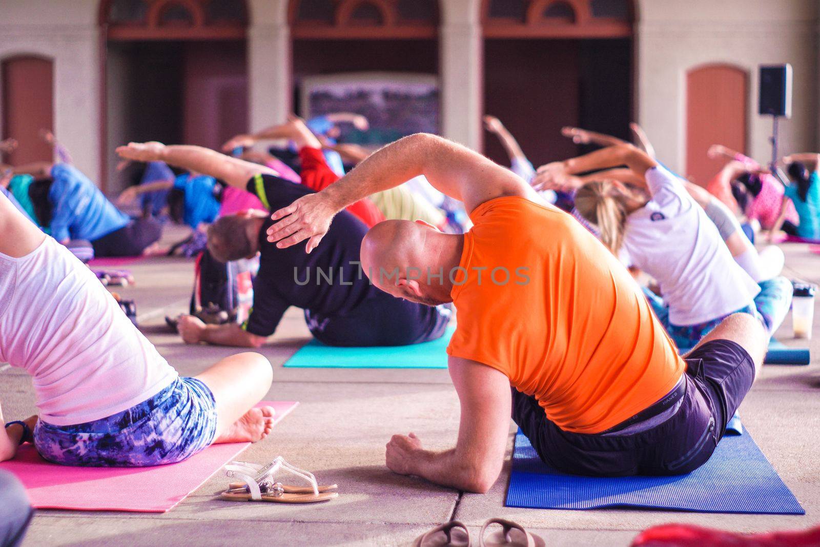 fitness, sport and healthy lifestyle concept - group of people doing yoga at a GYM, Mumbai. This image was taken on July 2019