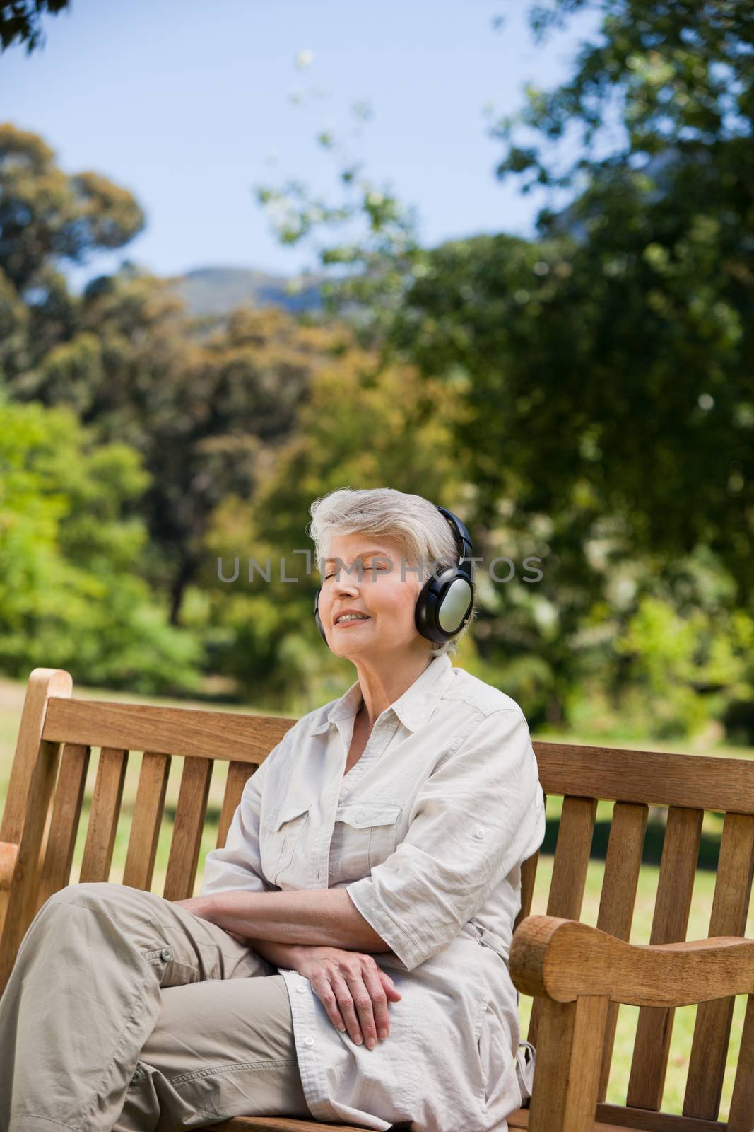 Elderly woman listening to some music by Wavebreakmedia