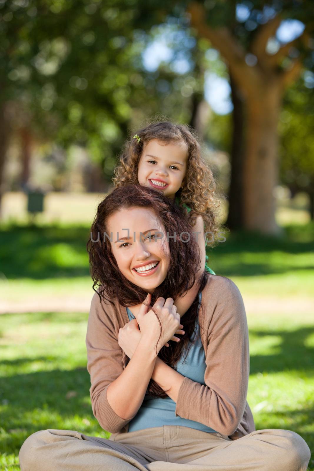 Woman hugging her daughter by Wavebreakmedia