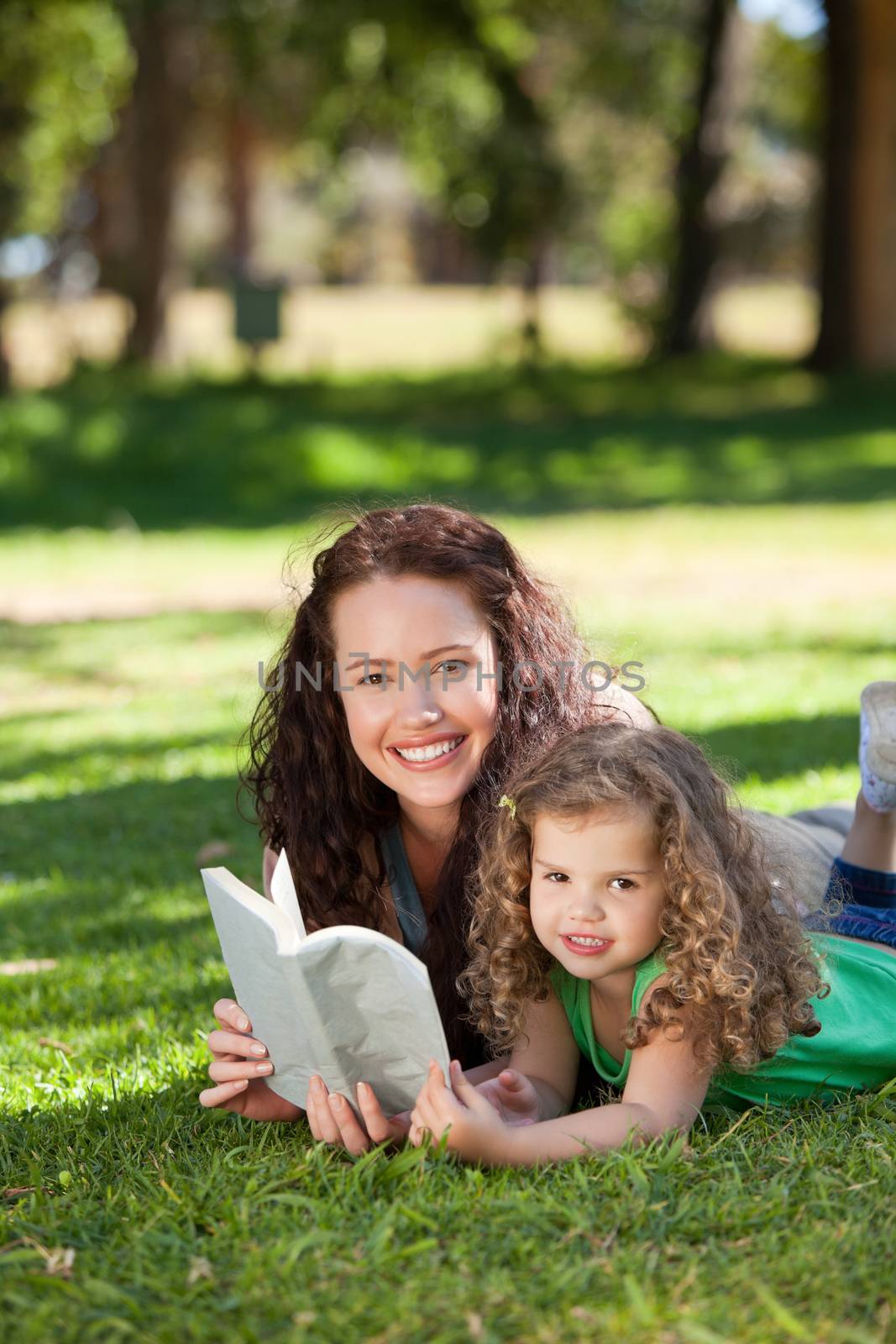 Woman with her daughter reading a book