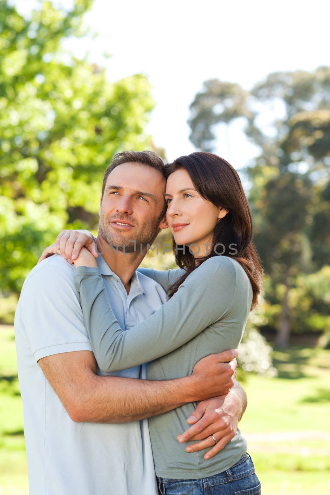 Radiant couple hugging in the park by Wavebreakmedia