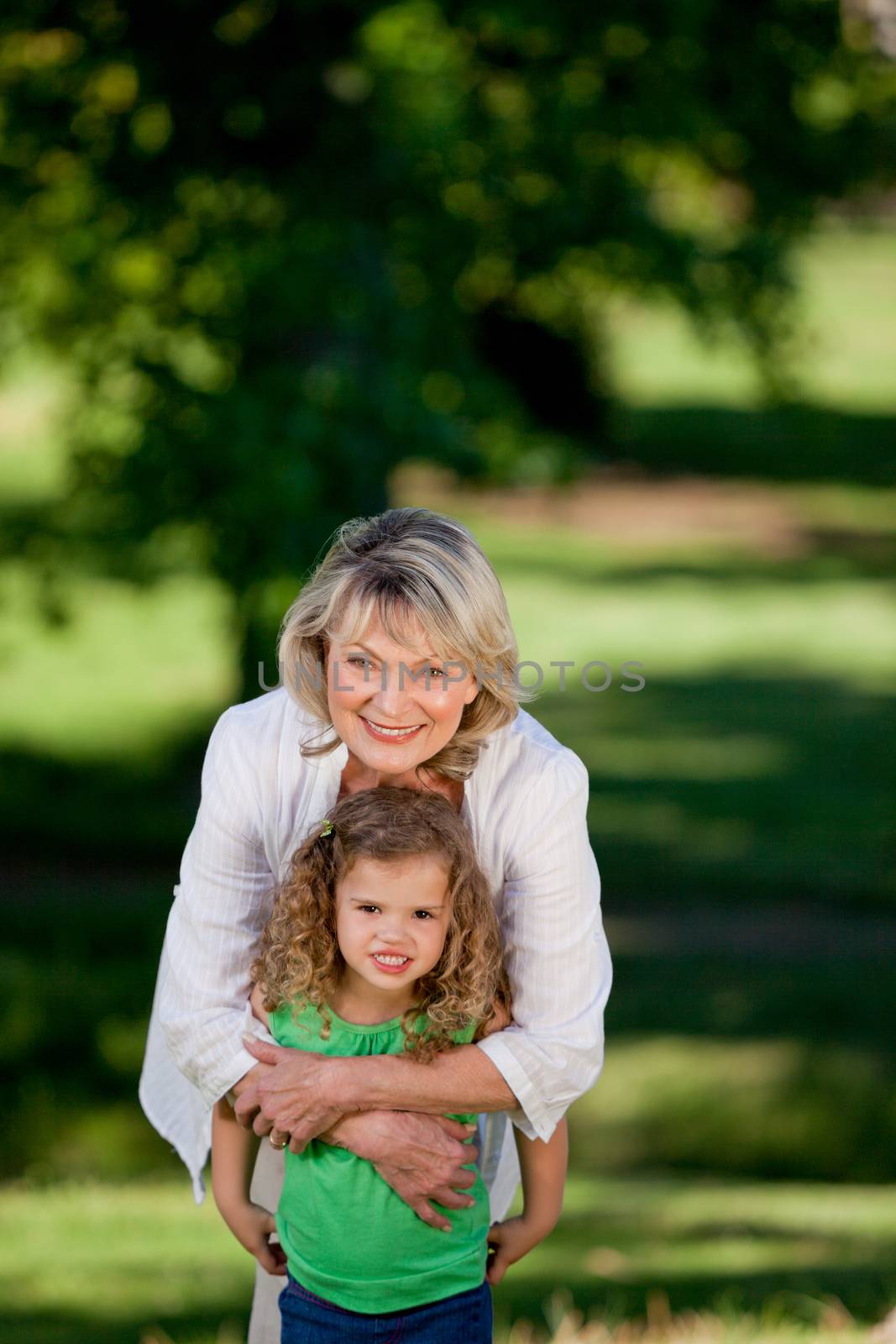 Grandmother and her granddaughter looking at the camera  by Wavebreakmedia
