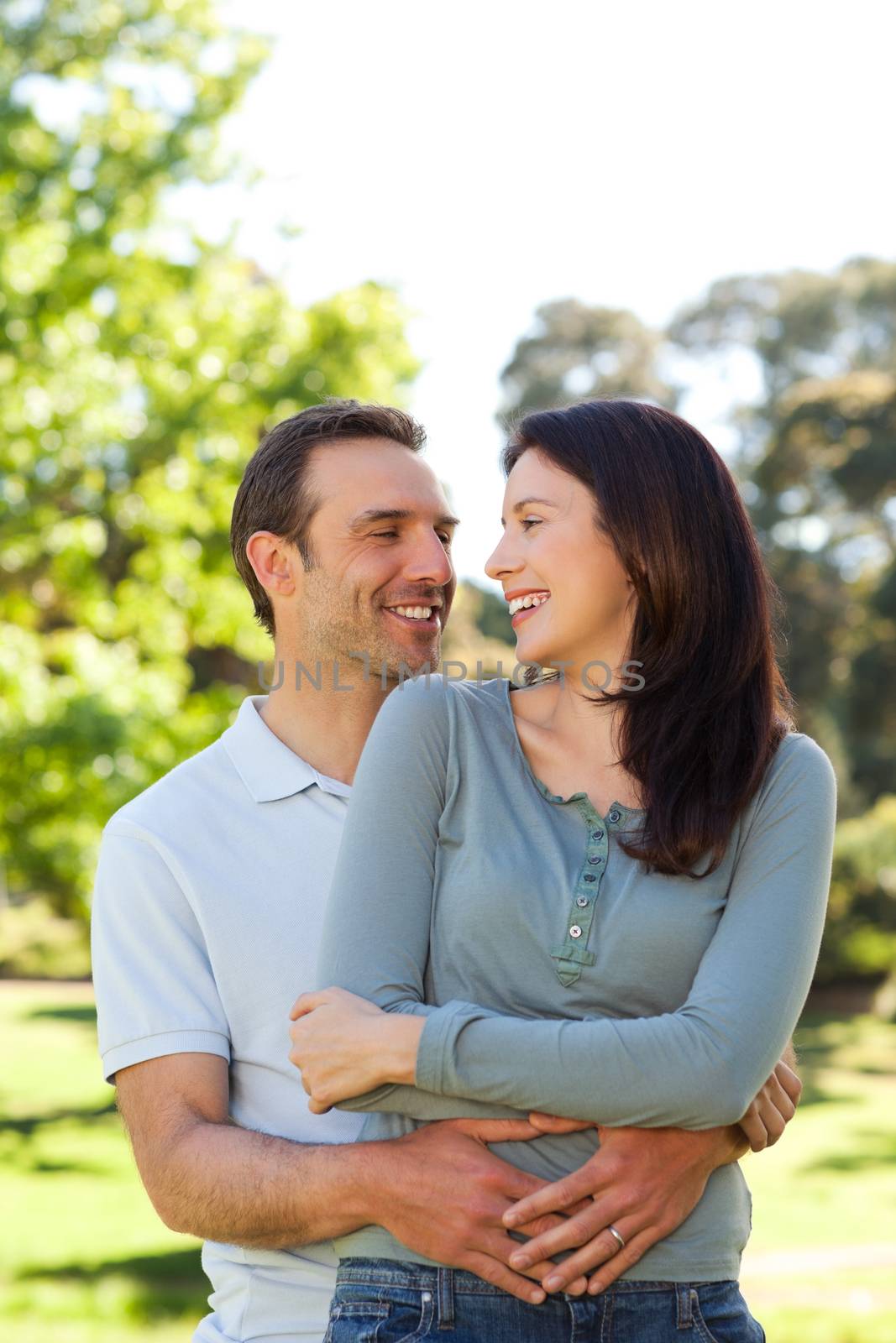 Beautiful couple hugging in the park by Wavebreakmedia