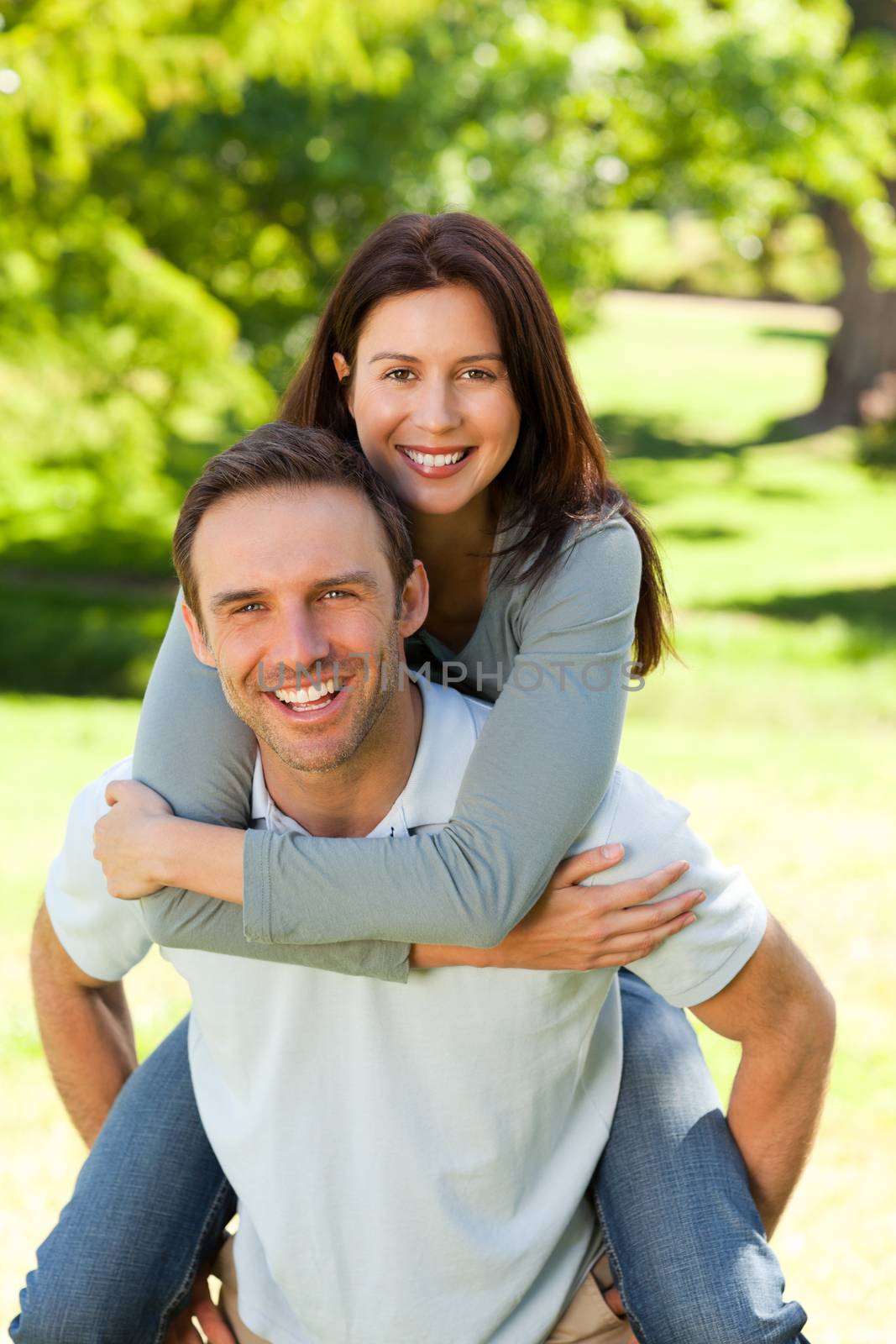 Man giving wife a piggyback by Wavebreakmedia