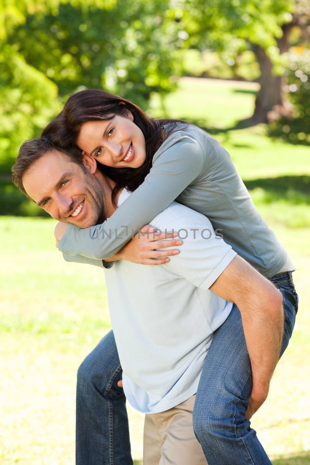 Man giving wife a piggyback by Wavebreakmedia