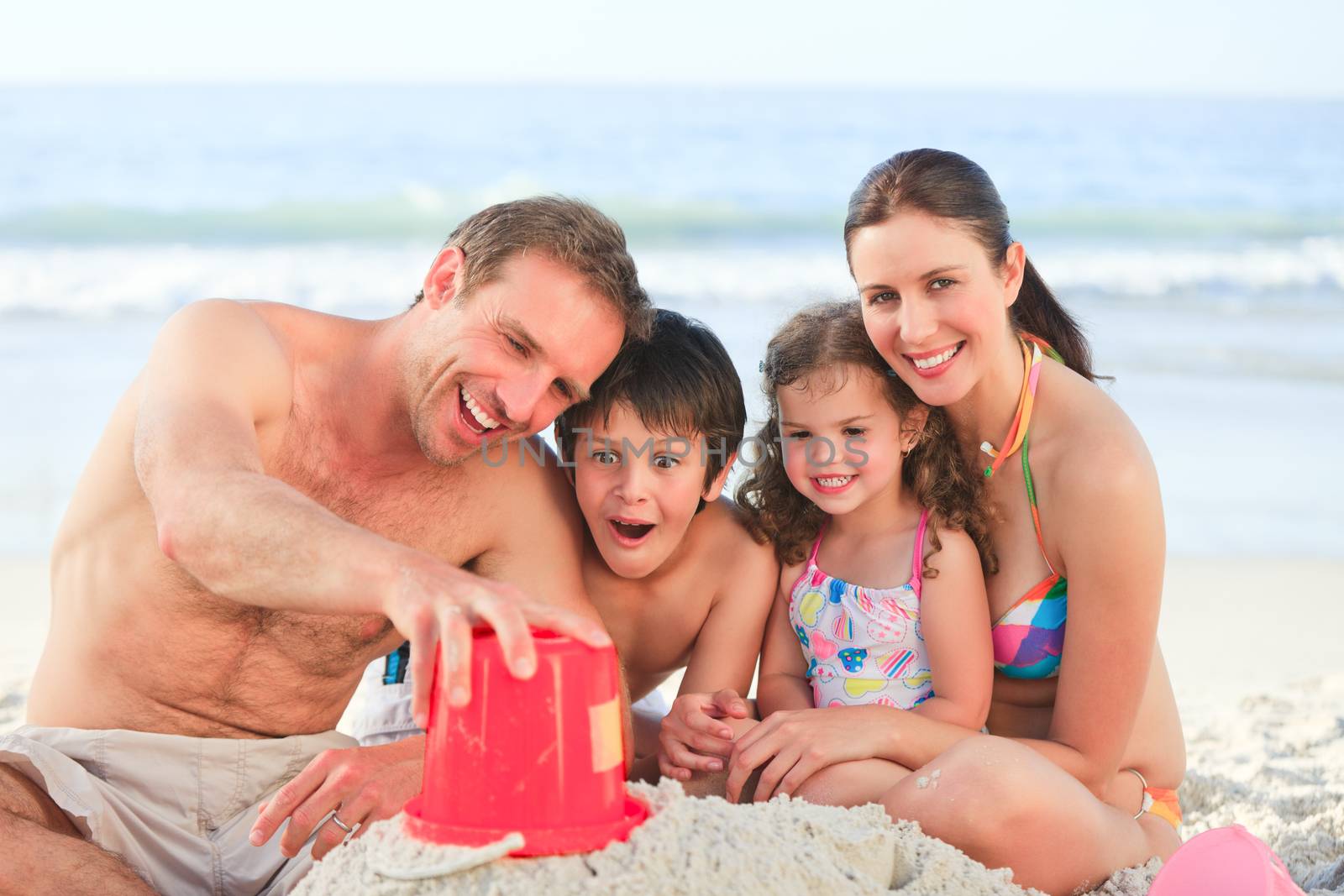 Family at the beach by Wavebreakmedia