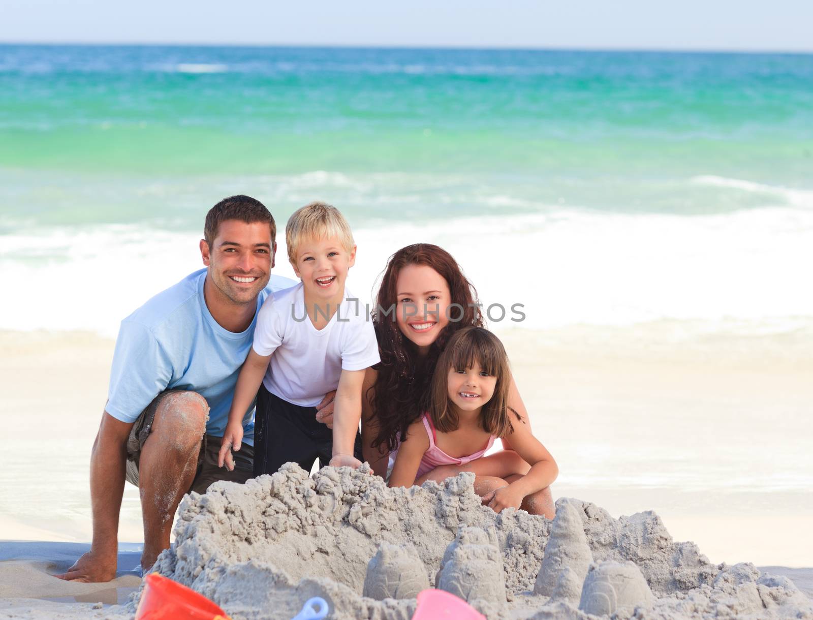 Radiant family at the beach by Wavebreakmedia