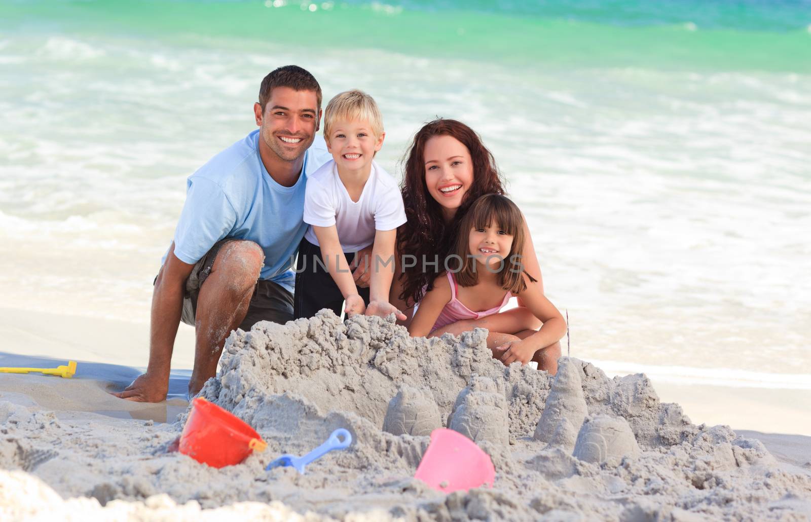 Radiant family at the beach by Wavebreakmedia