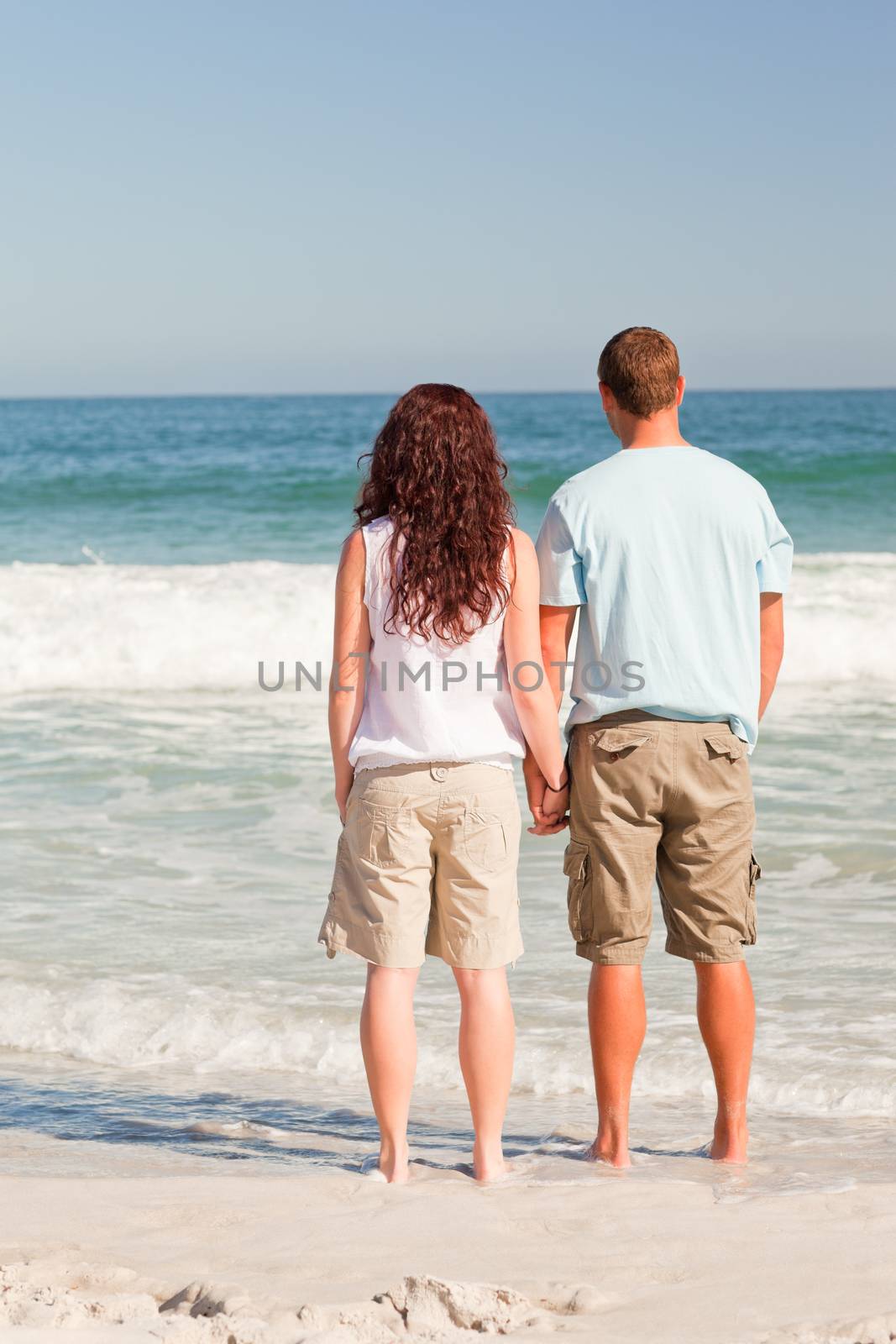 Lovers looking at the sea by Wavebreakmedia