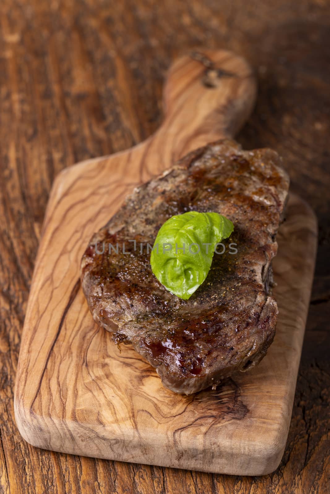 overview of a grilled steak on wood by bernjuer