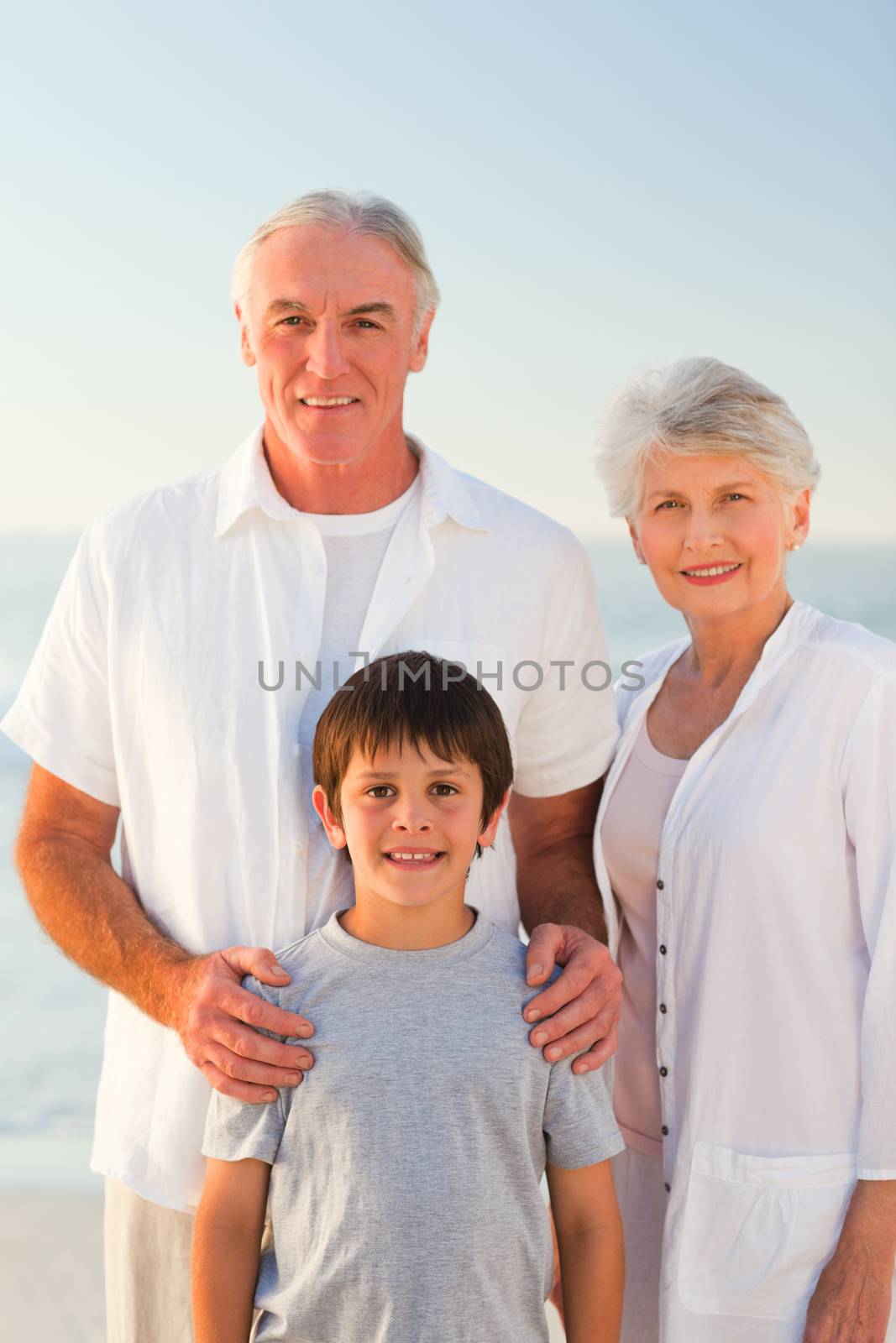 Grandparents with their grandson at the beach