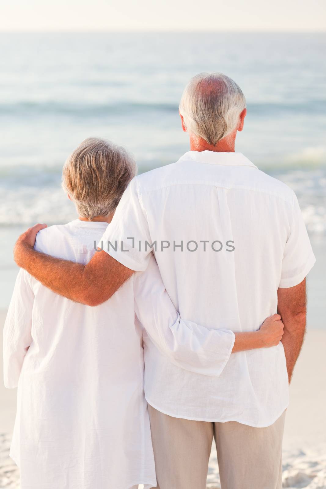 Man hugging his wife on the beach by Wavebreakmedia