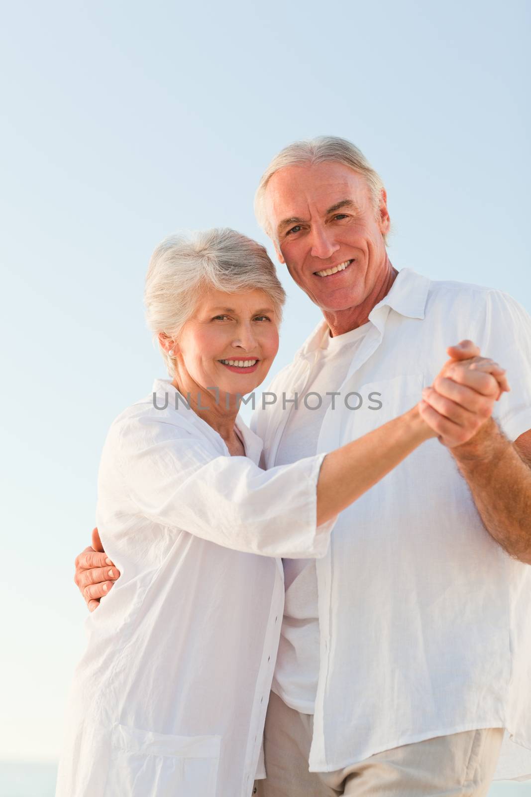 Senior couple dancing on the beach by Wavebreakmedia