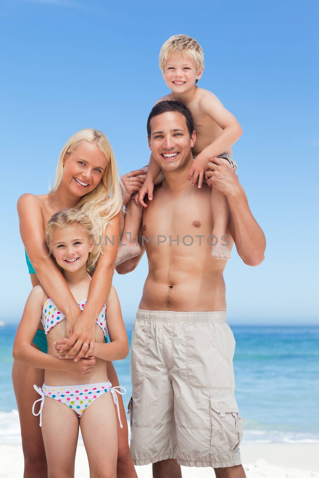 Happy family on the beach by Wavebreakmedia