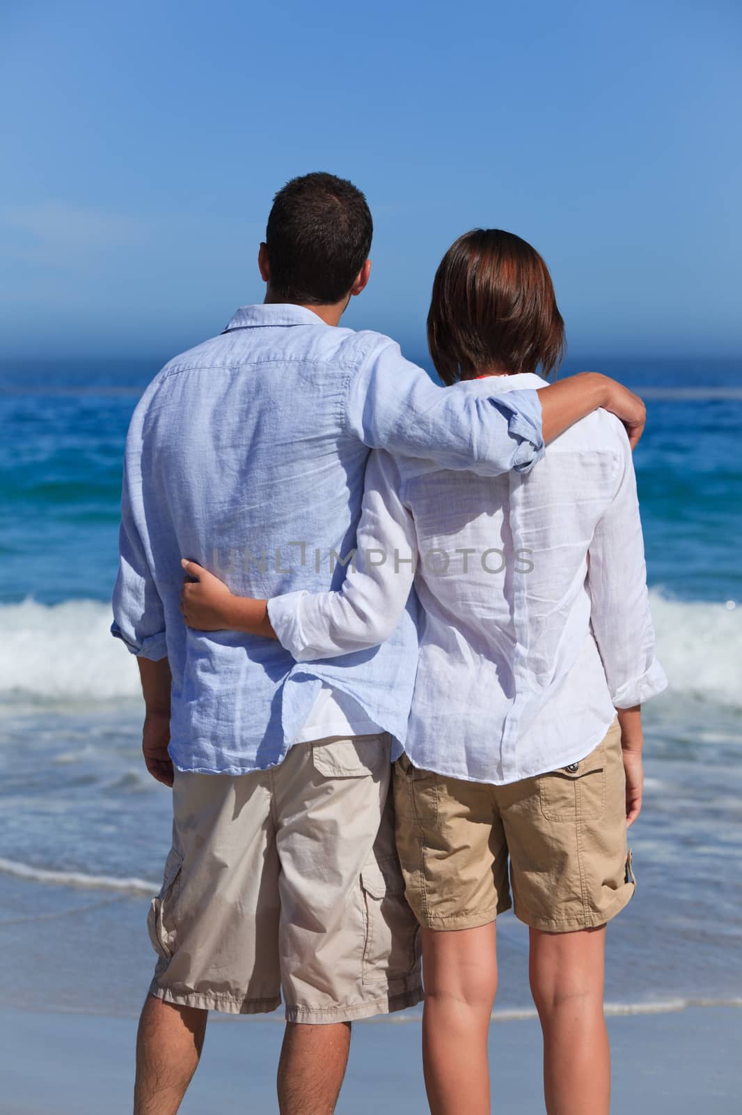 Enamored couple looking at the sea by Wavebreakmedia