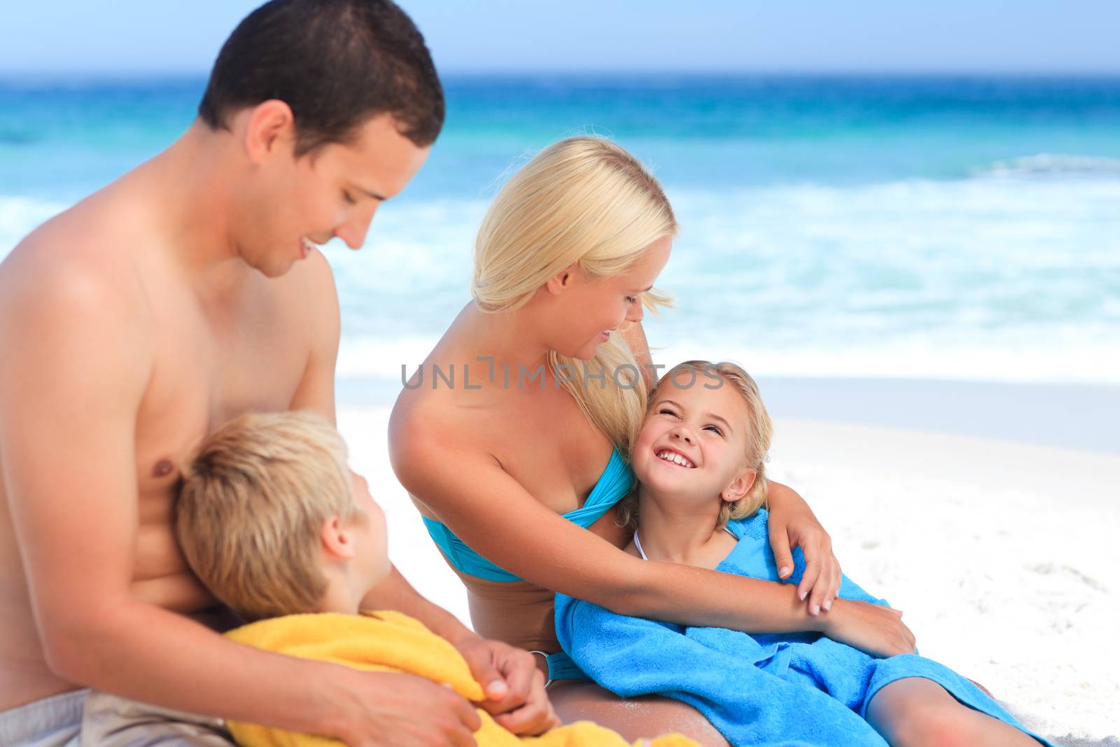 Parents with their children in their towels by Wavebreakmedia