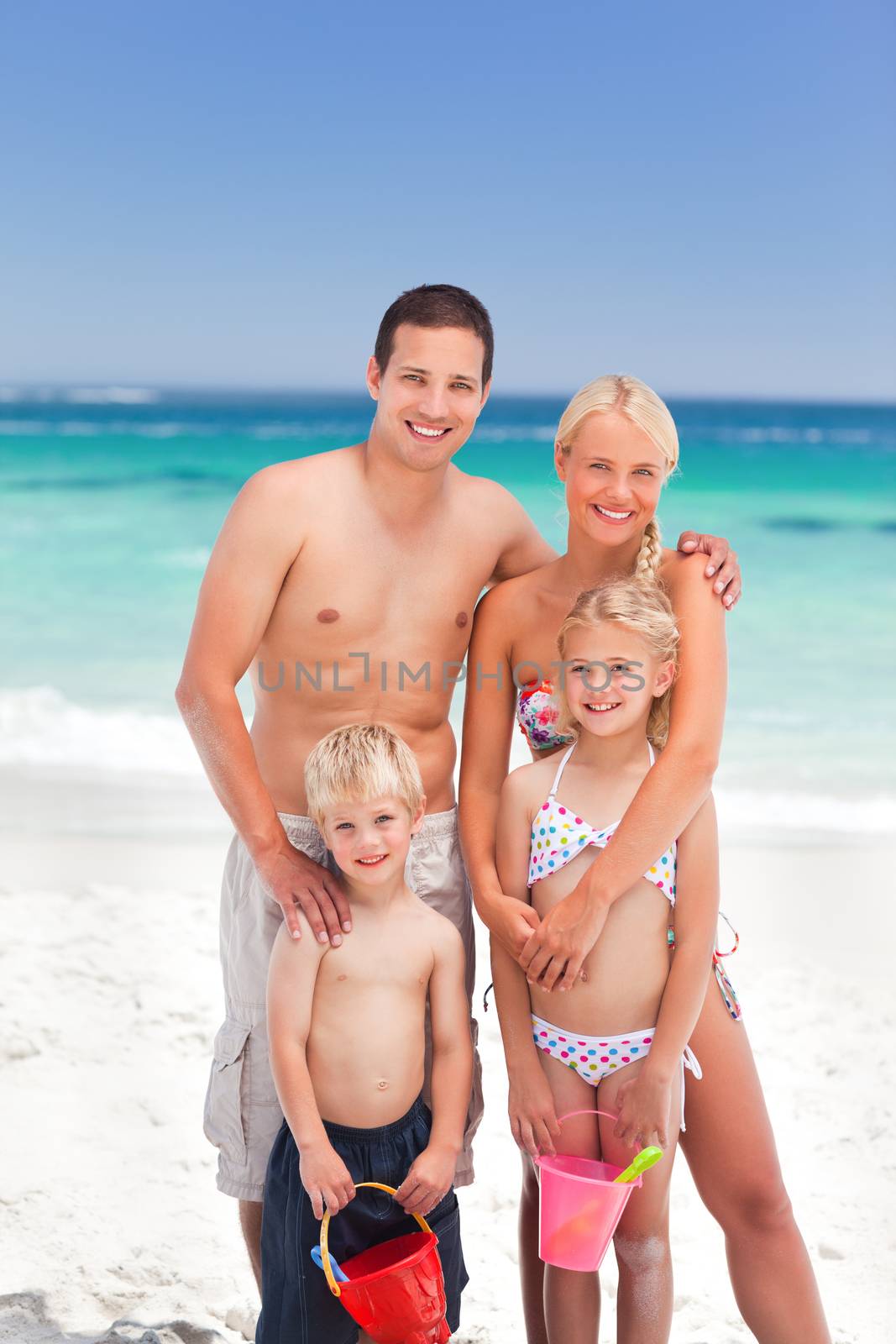 Radiant family on the beach by Wavebreakmedia