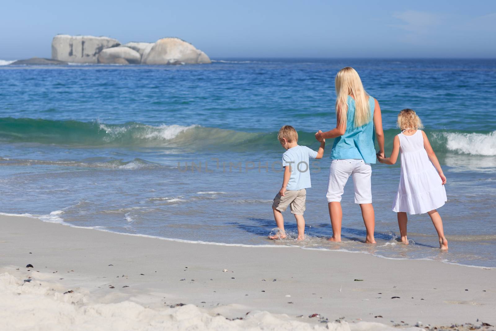 Family walking on the beach by Wavebreakmedia