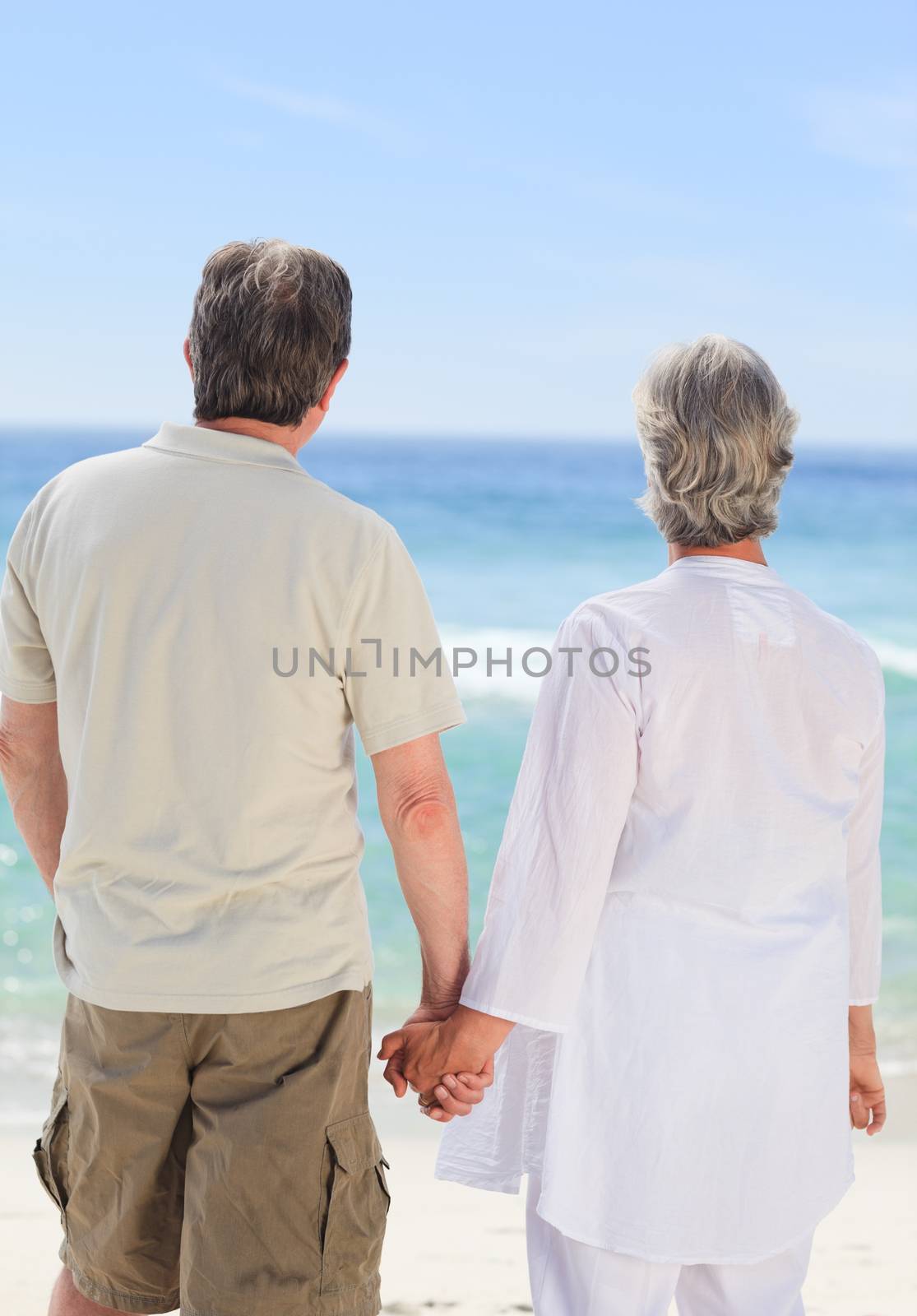Happy couple on the beach by Wavebreakmedia