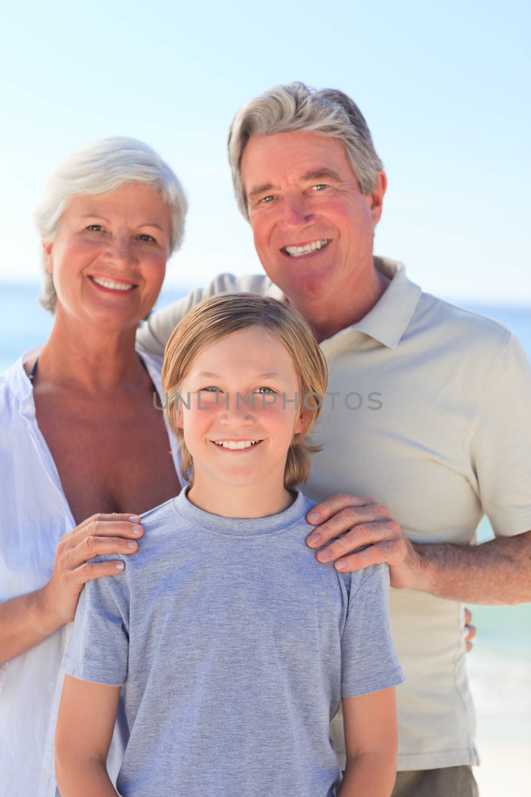 Grandparents with their grandson at the beach by Wavebreakmedia
