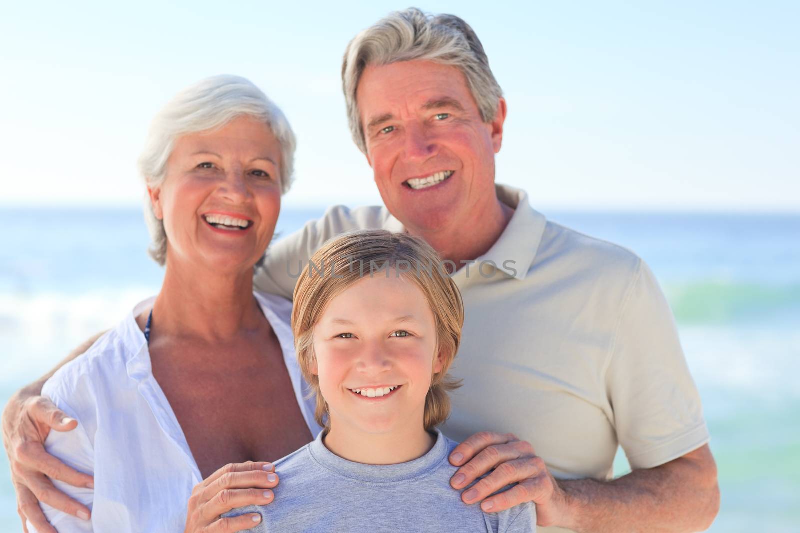 Grandparents with their grandson at the beach