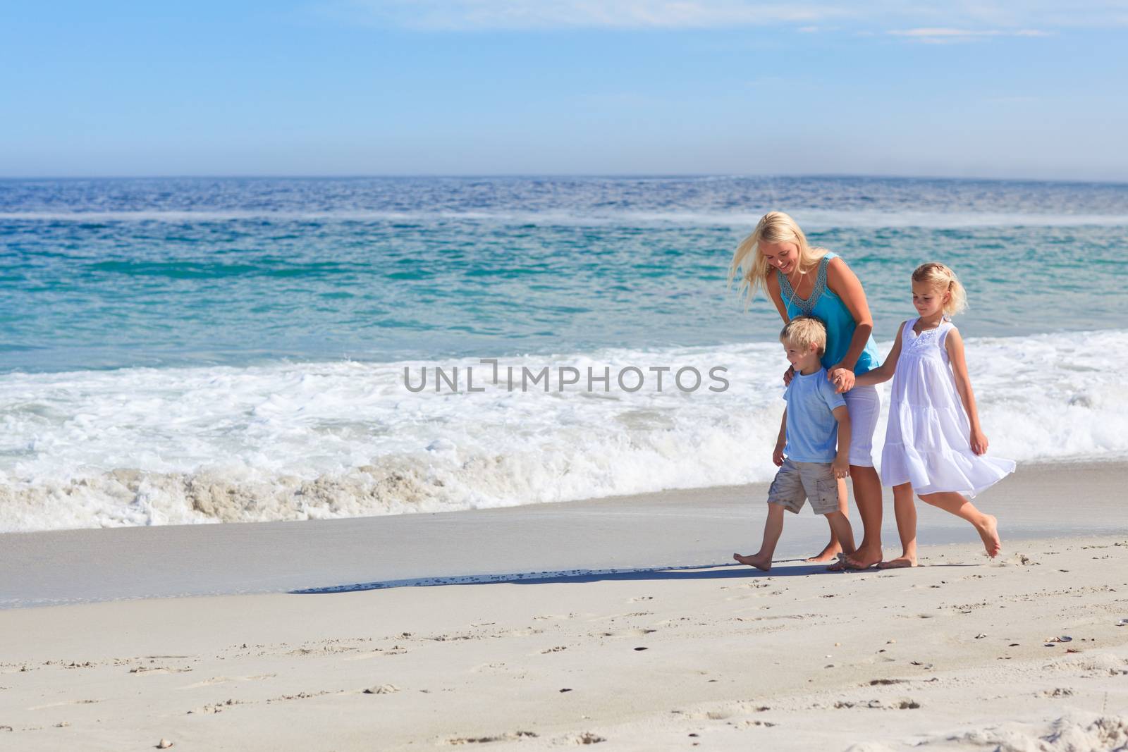 Family walking on the beach by Wavebreakmedia
