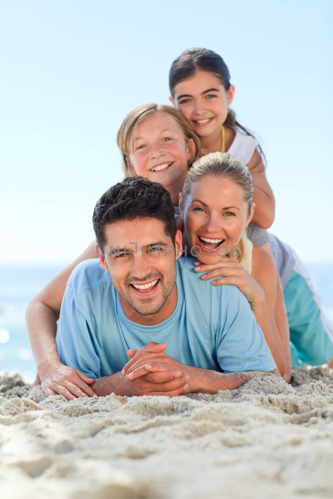 Portrait of a smiling famiy on the beach by Wavebreakmedia