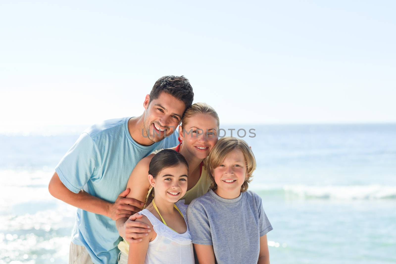 Joyful family at the beach by Wavebreakmedia