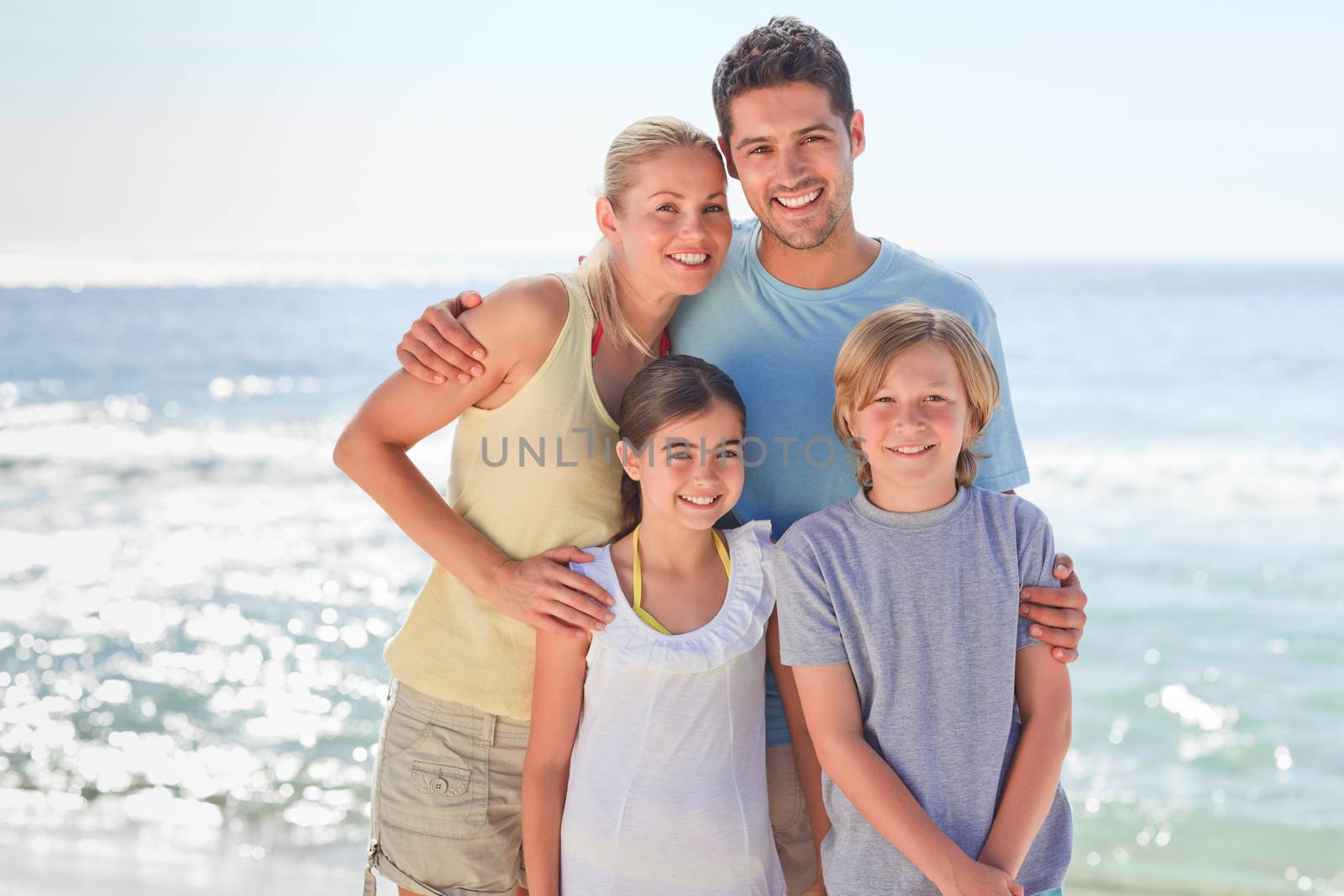 Joyful family at the beach by Wavebreakmedia