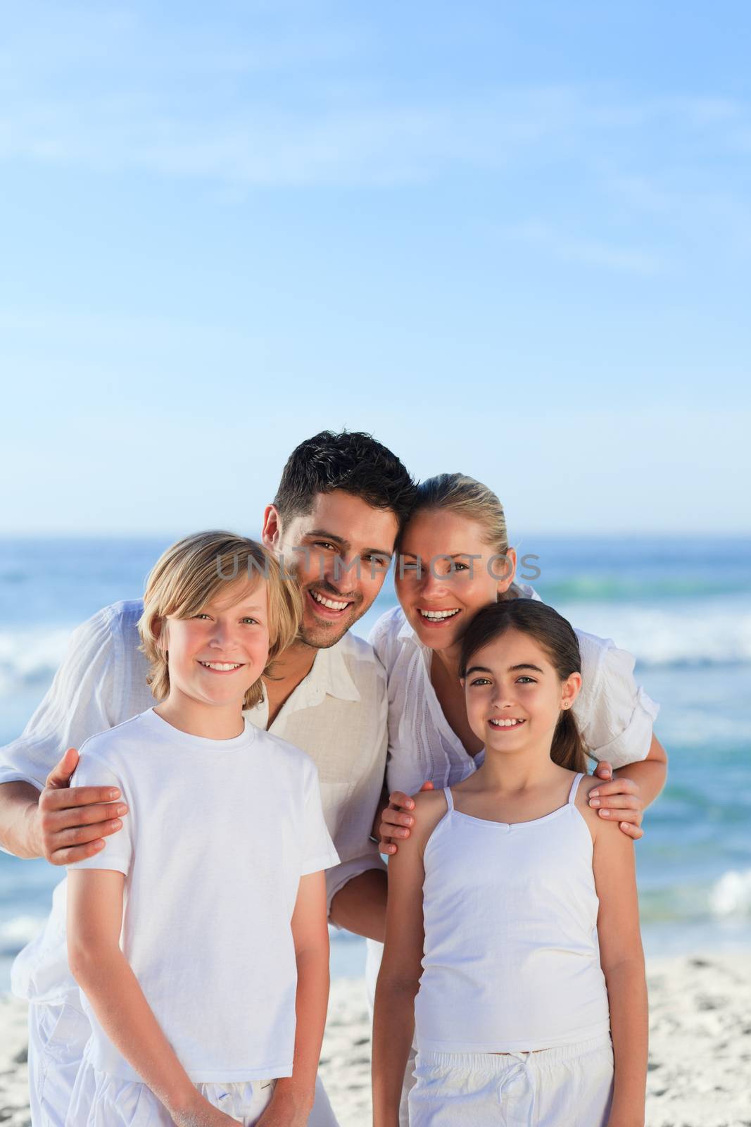 Portrait of a cute family at the beach