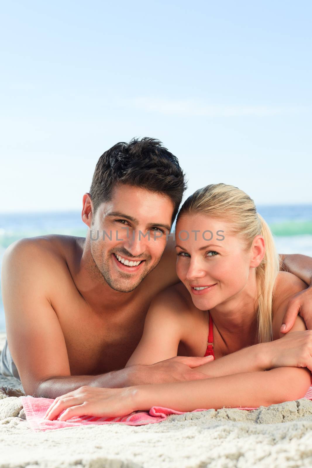 Lovers lying down on the beach