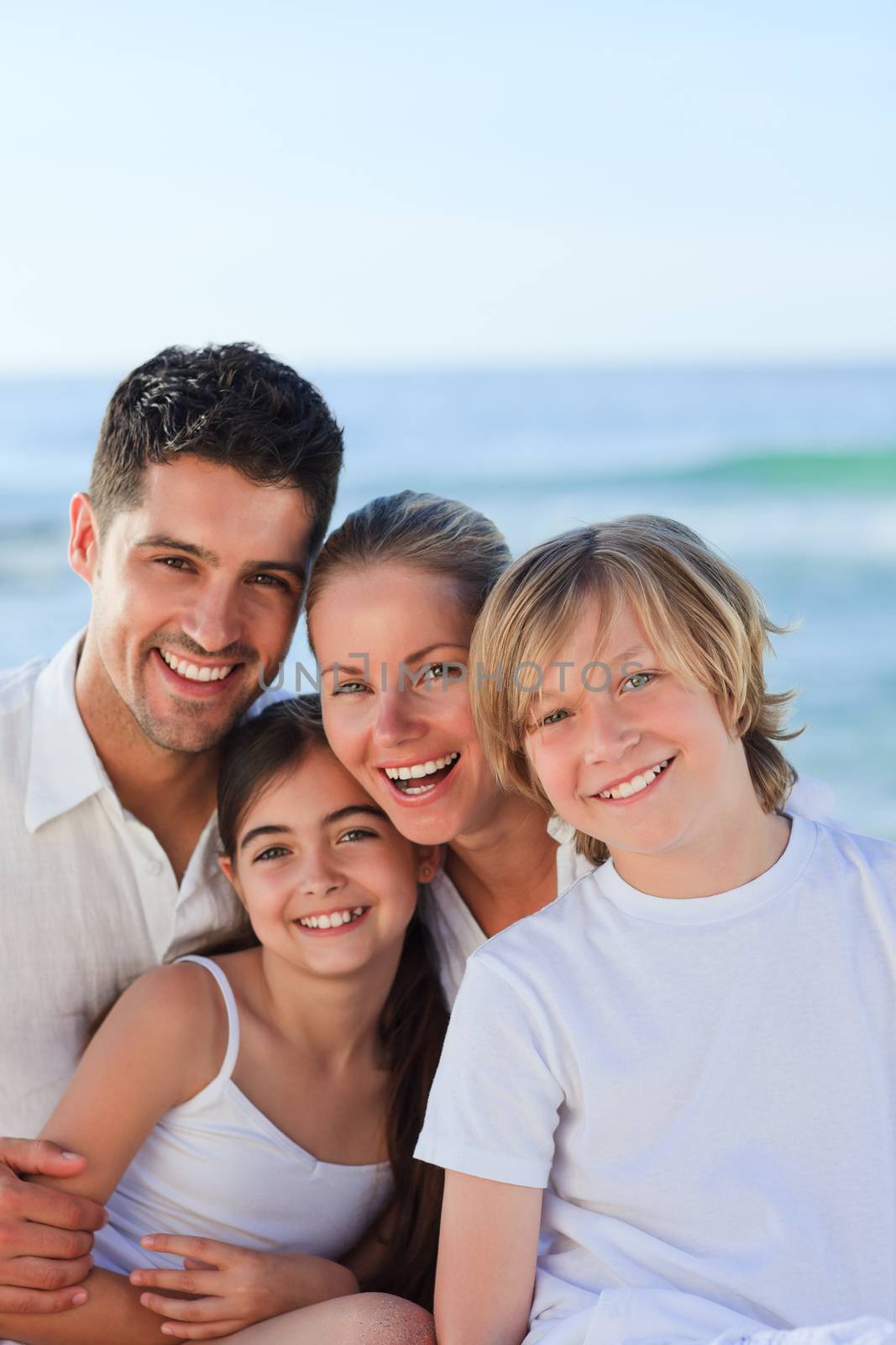 Portrait of a cute family at the beach